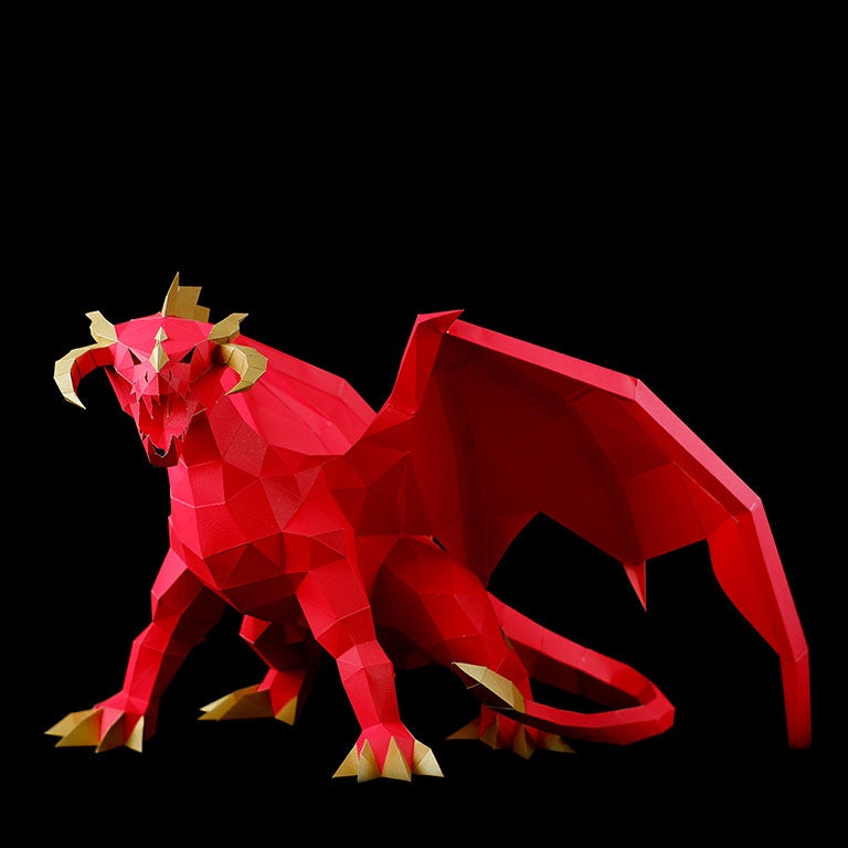 A stunning red and gold paper dragon model in a predatory stance with wings spread, showcasing intricate details and craftsmanship.