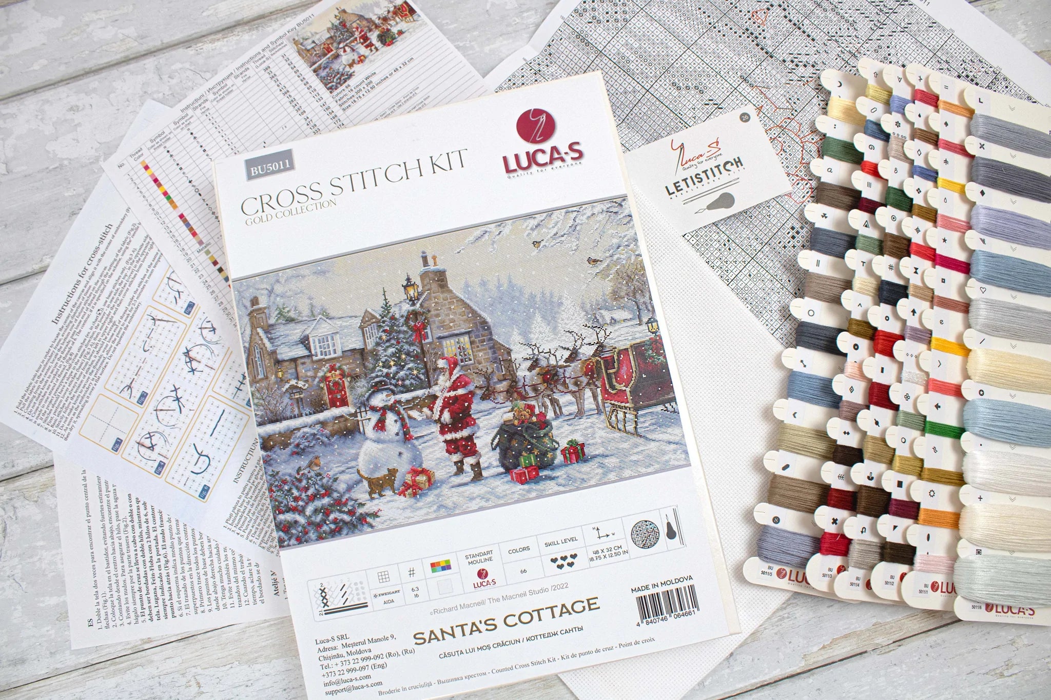 Santa's Cottage BU5011L Counted Cross-Stitch Kit featuring Aida canvas, colorful threads, and included needle and instructions.