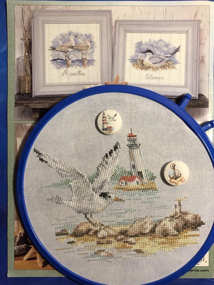 Seagulls 3-30 Cross-stitch kit featuring white aida fabric, colorful threads, and an embroidery needle.