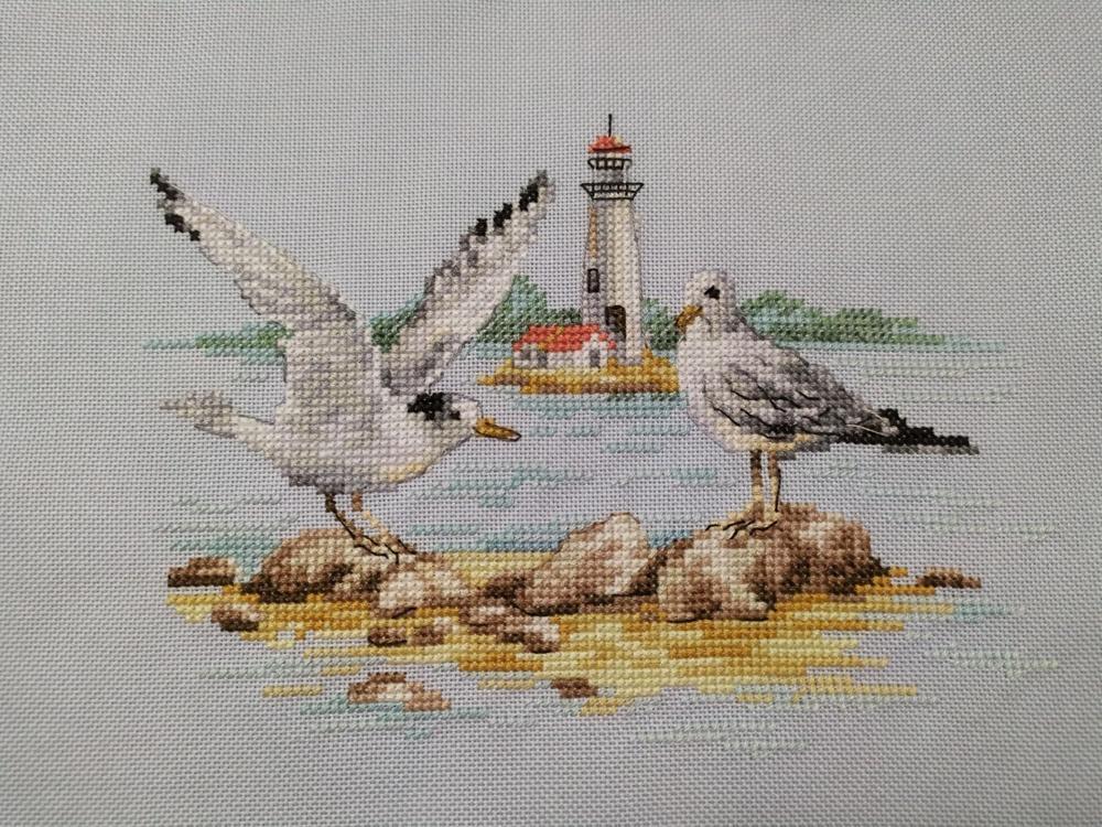 Seagulls 3-30 Cross-stitch kit featuring white aida fabric, colorful threads, and an embroidery needle.