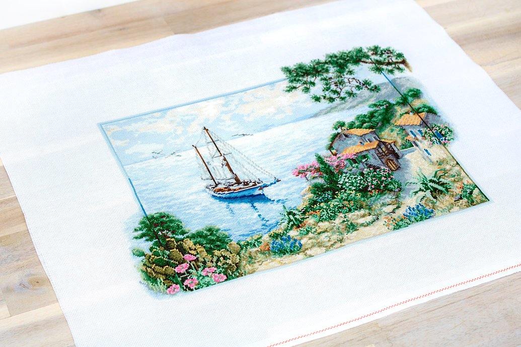 Seascape B2343L Counted Cross-Stitch Kit featuring Aida canvas, colorful threads, and needle for crafting.