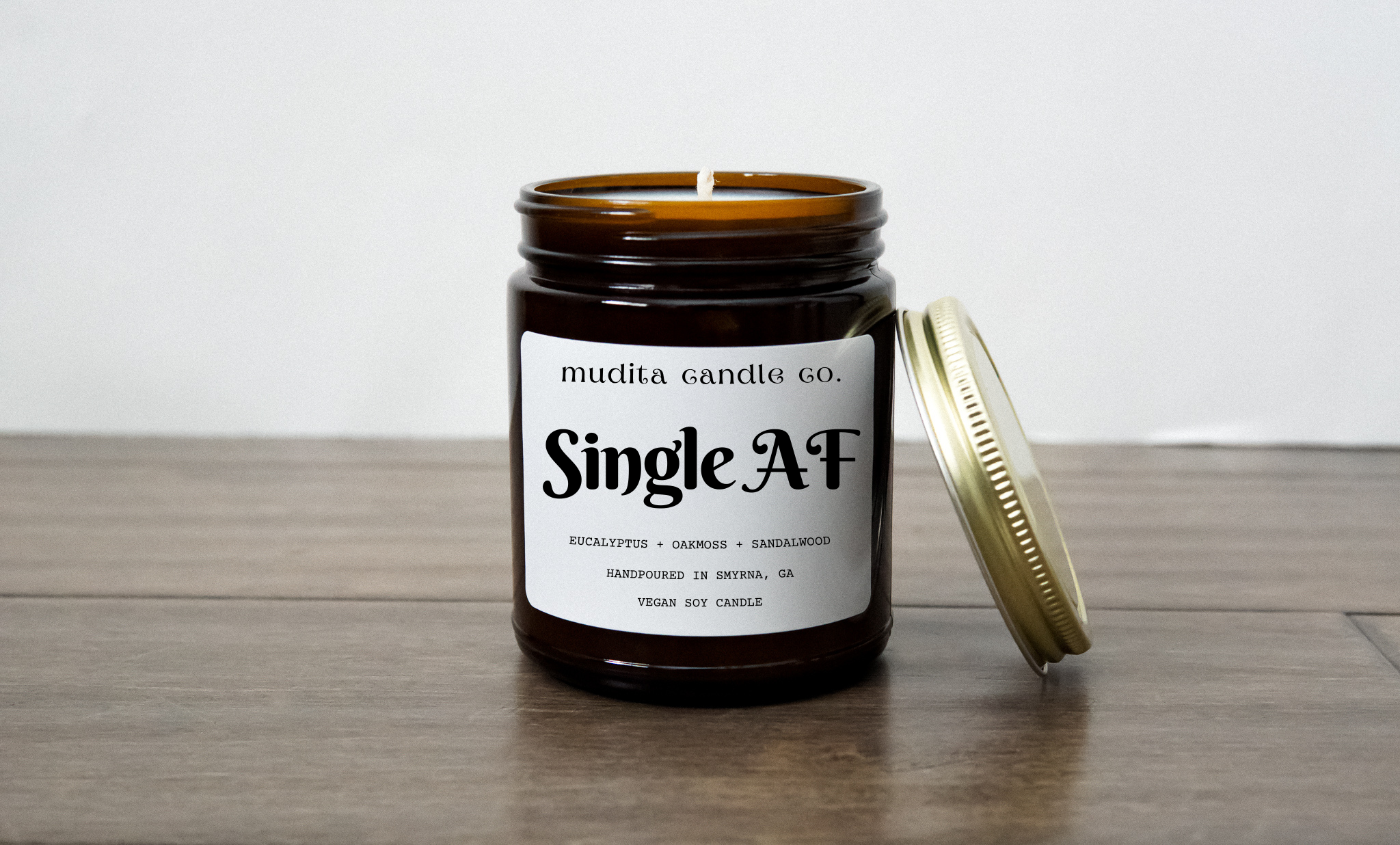 Single AF candle in an amber glass jar with a gold lid, showcasing its elegant design and natural ingredients.