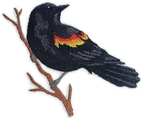 A vibrant embroidered patch featuring a single red-winged blackbird, showcasing intricate details and colors on a cotton base.