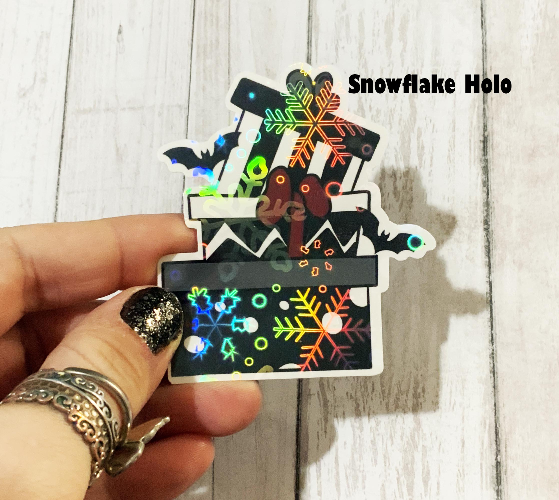 A colorful vinyl sticker featuring a skeleton wearing an ugly Christmas sweater, perfect for festive decorations.