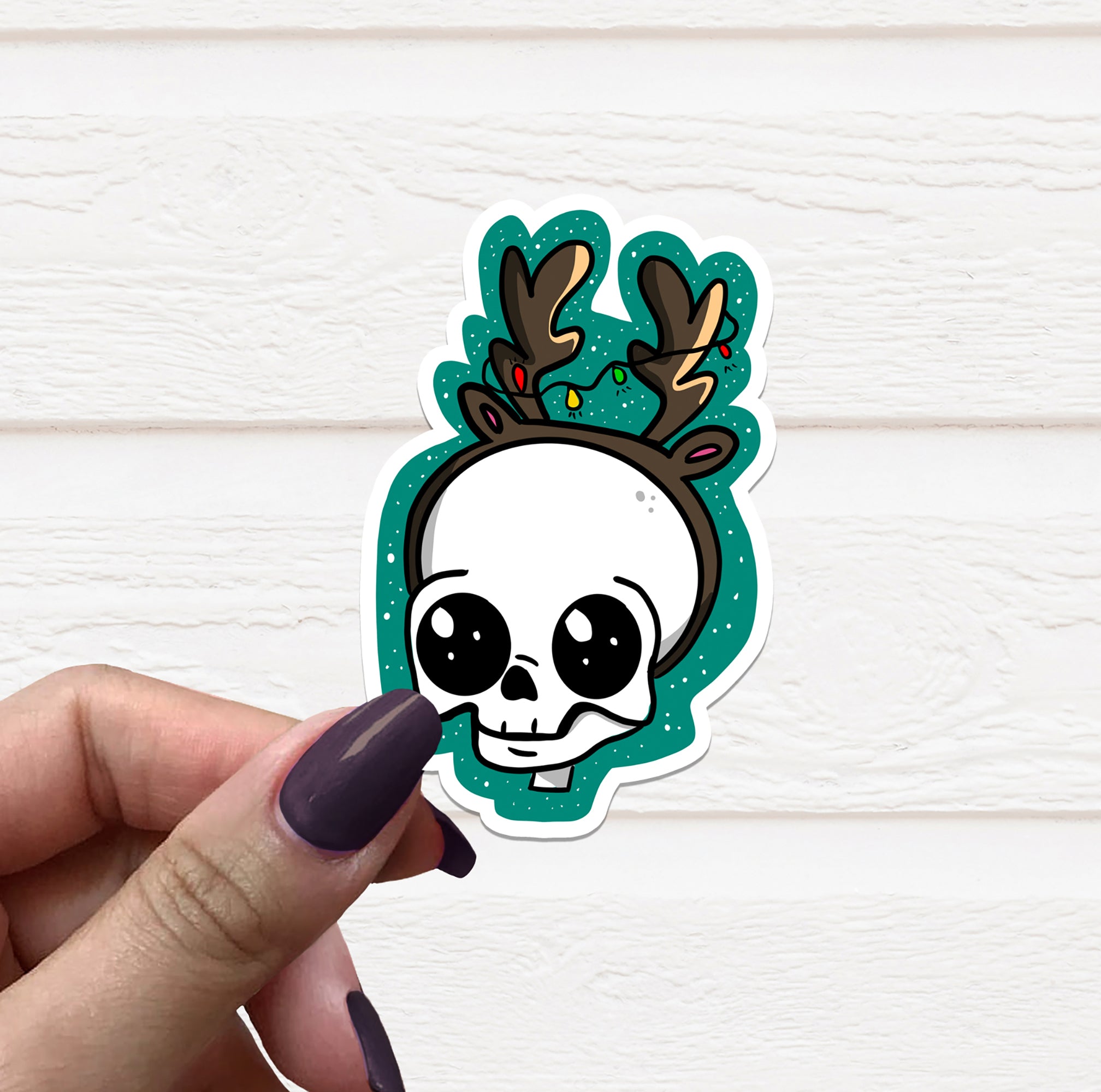 A colorful Skull Reindeer Vinyl Sticker featuring a festive design, perfect for holiday decorations.