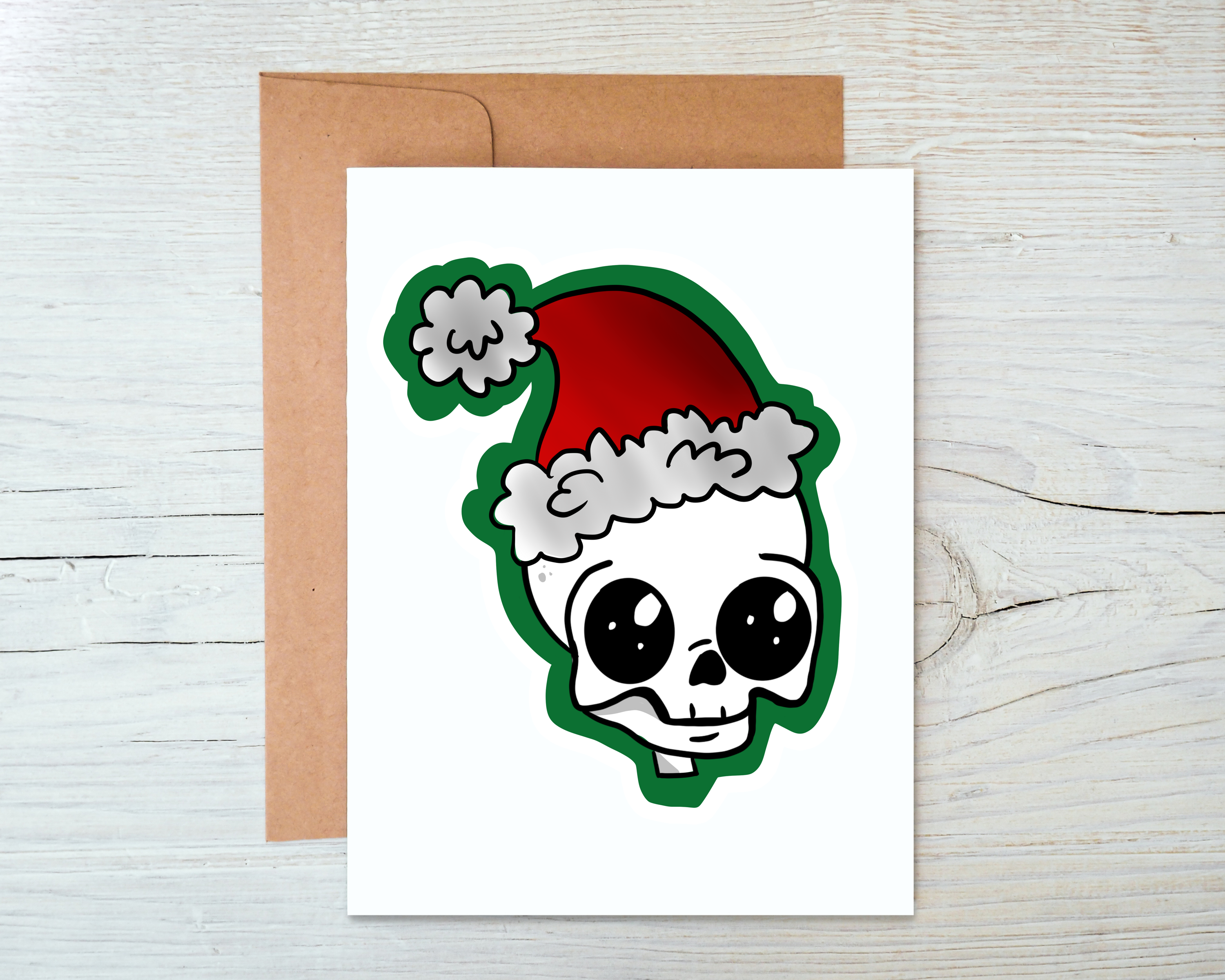 A Skull Santa Card featuring a unique design with a skull wearing a Santa hat, blank inside, accompanied by a kraft envelope.