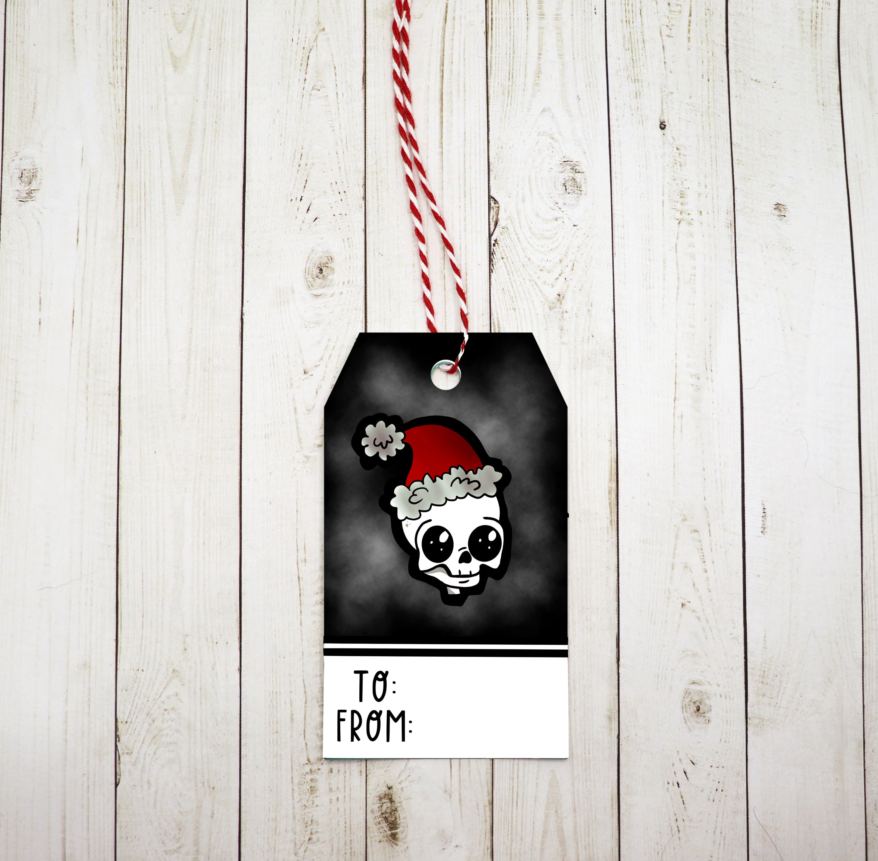 A set of Skull Santa Gift Tags featuring a playful skull design, red and white twine, and printed on heavy white cardstock.