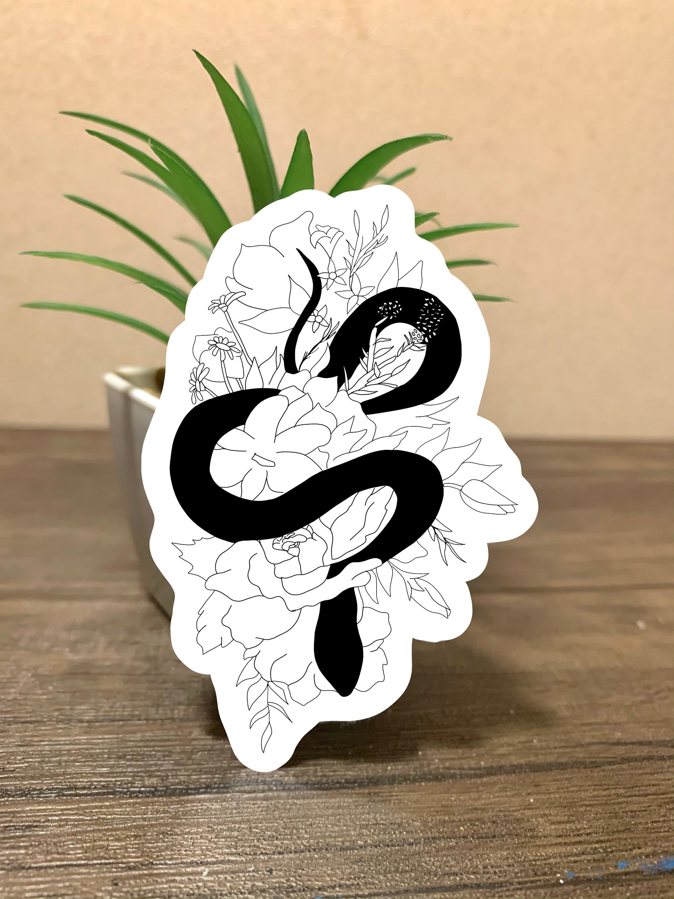 A cute snake floral sticker featuring a snake intertwined with colorful flowers, perfect for personalizing items.