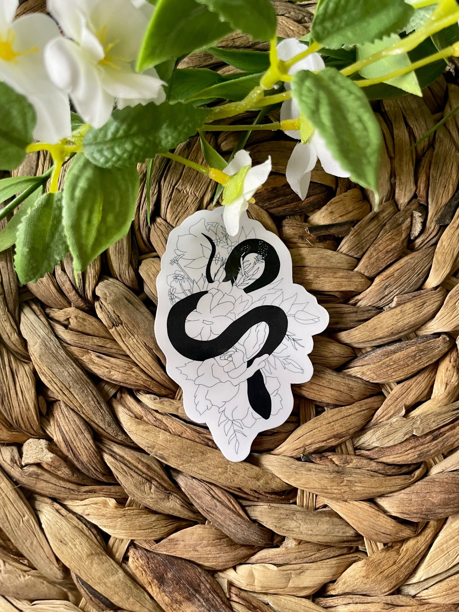 A cute snake floral sticker featuring a snake intertwined with colorful flowers, perfect for personalizing items.