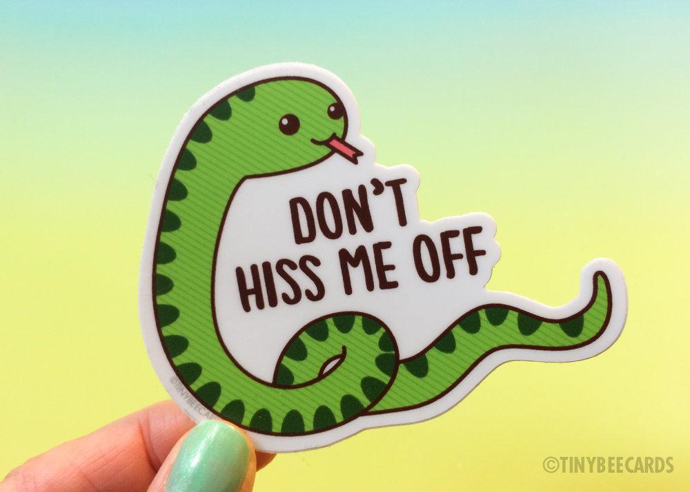 A colorful vinyl sticker featuring a happy snake with the pun 'Don't Hiss Me Off', ideal for personalizing items.