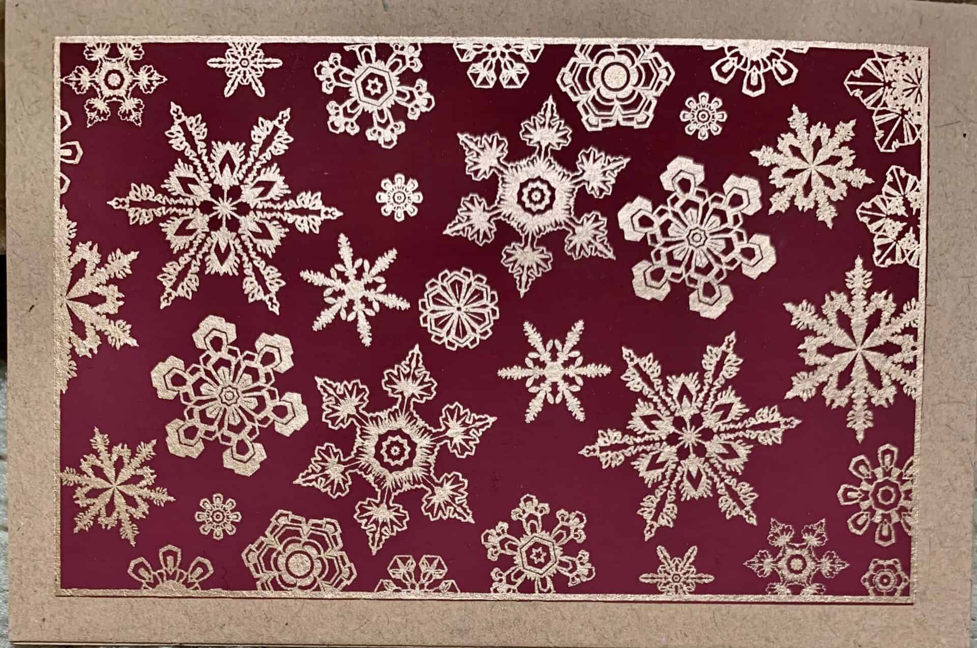 A collection of handmade SNOWFLAKE greeting cards featuring unique textures and vintage designs, accompanied by vanilla envelopes.