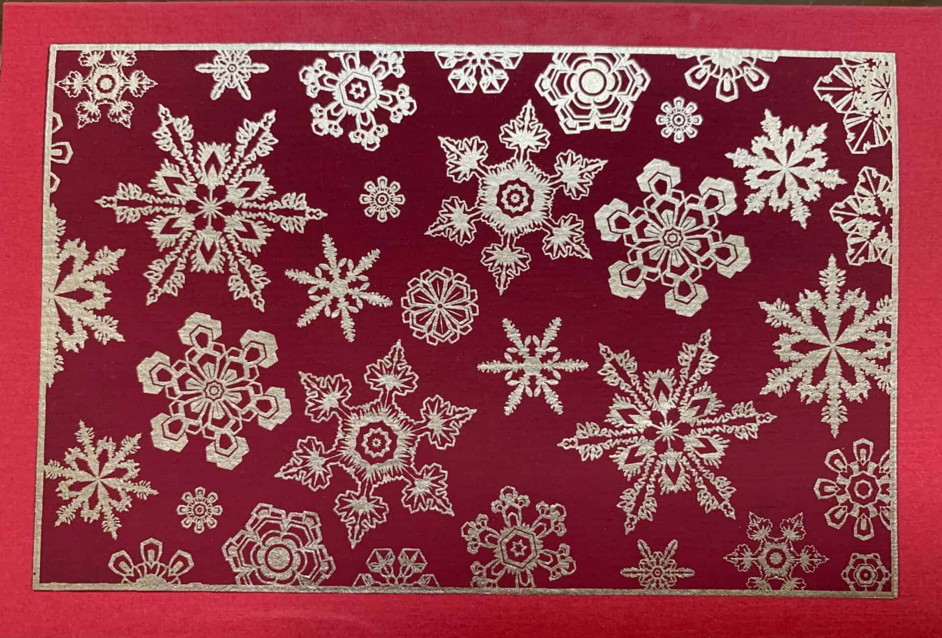 A collection of handmade SNOWFLAKE greeting cards featuring unique textures and vintage designs, accompanied by vanilla envelopes.