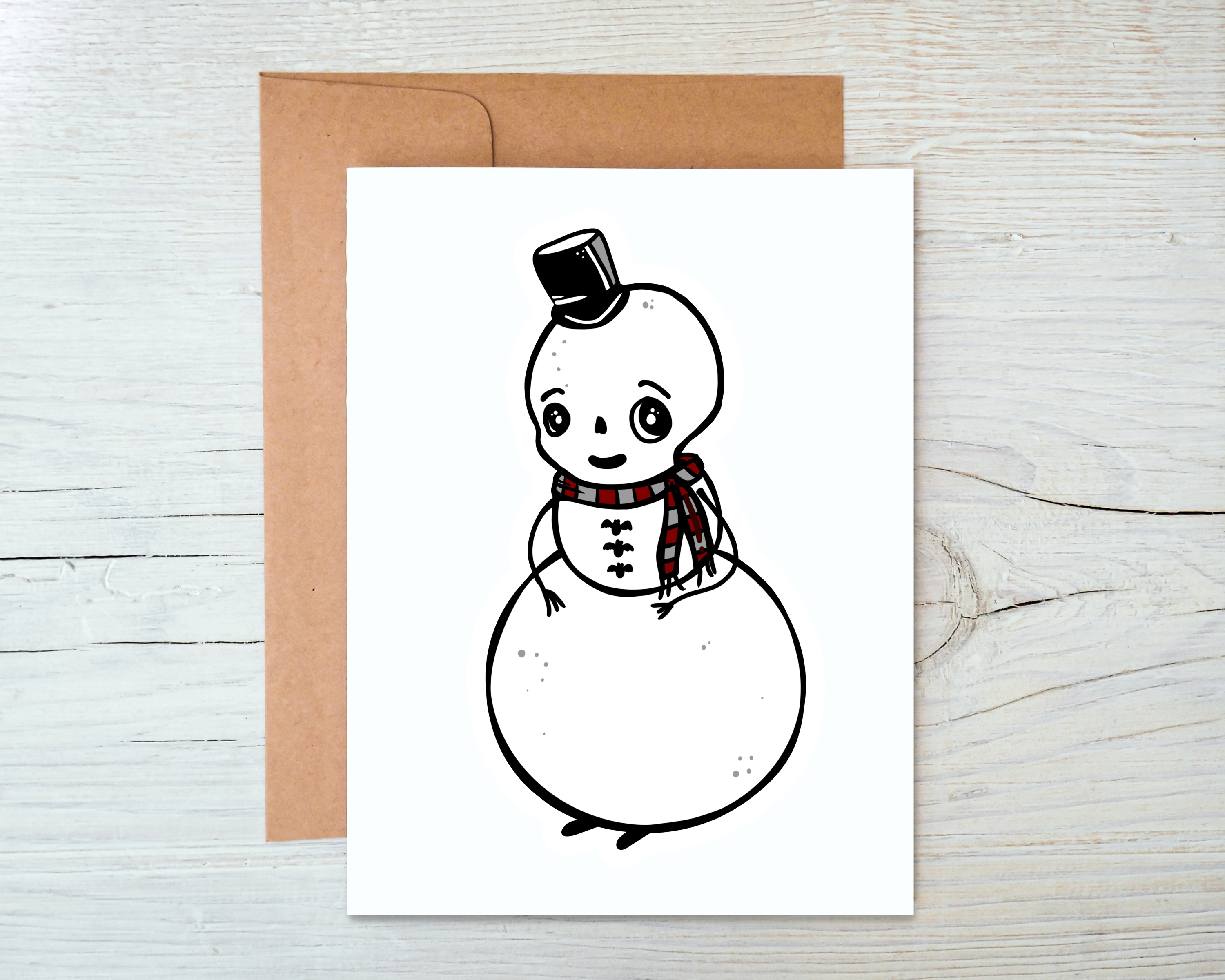 A festive snowman card with a blank interior, accompanied by a kraft envelope, perfect for holiday greetings.