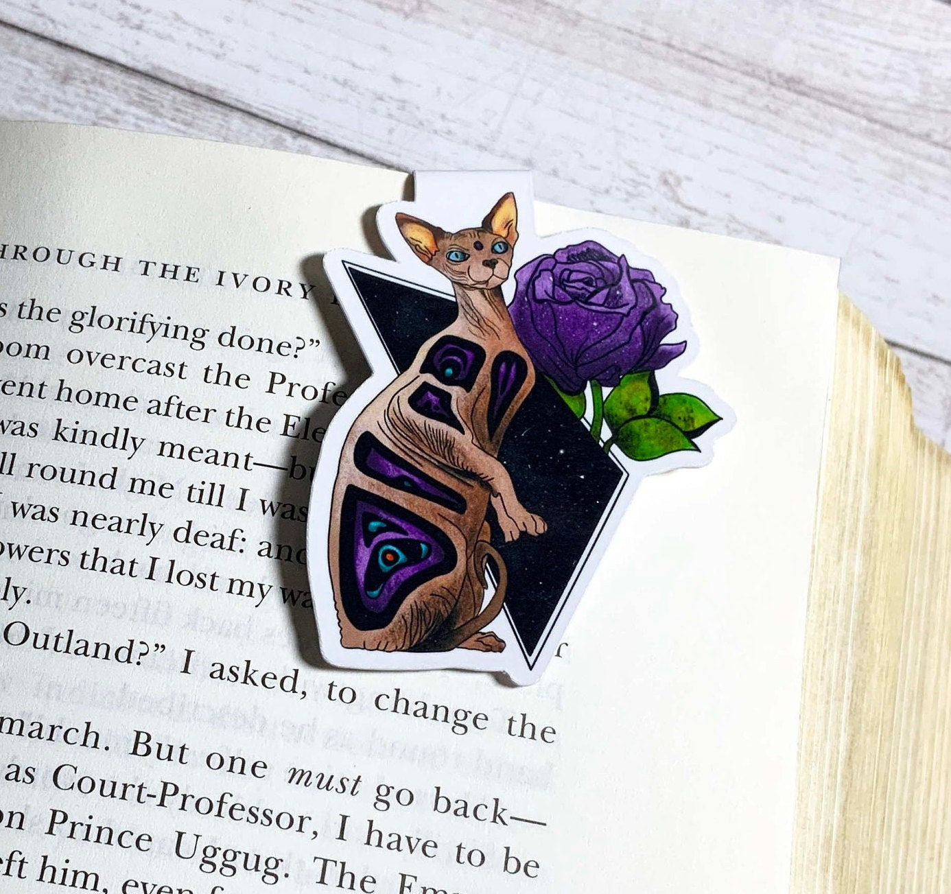 A stylish Sphynx Cat Bookmark featuring a unique design, double-sided, scratch and splash resistant, with strong magnets for secure page holding.