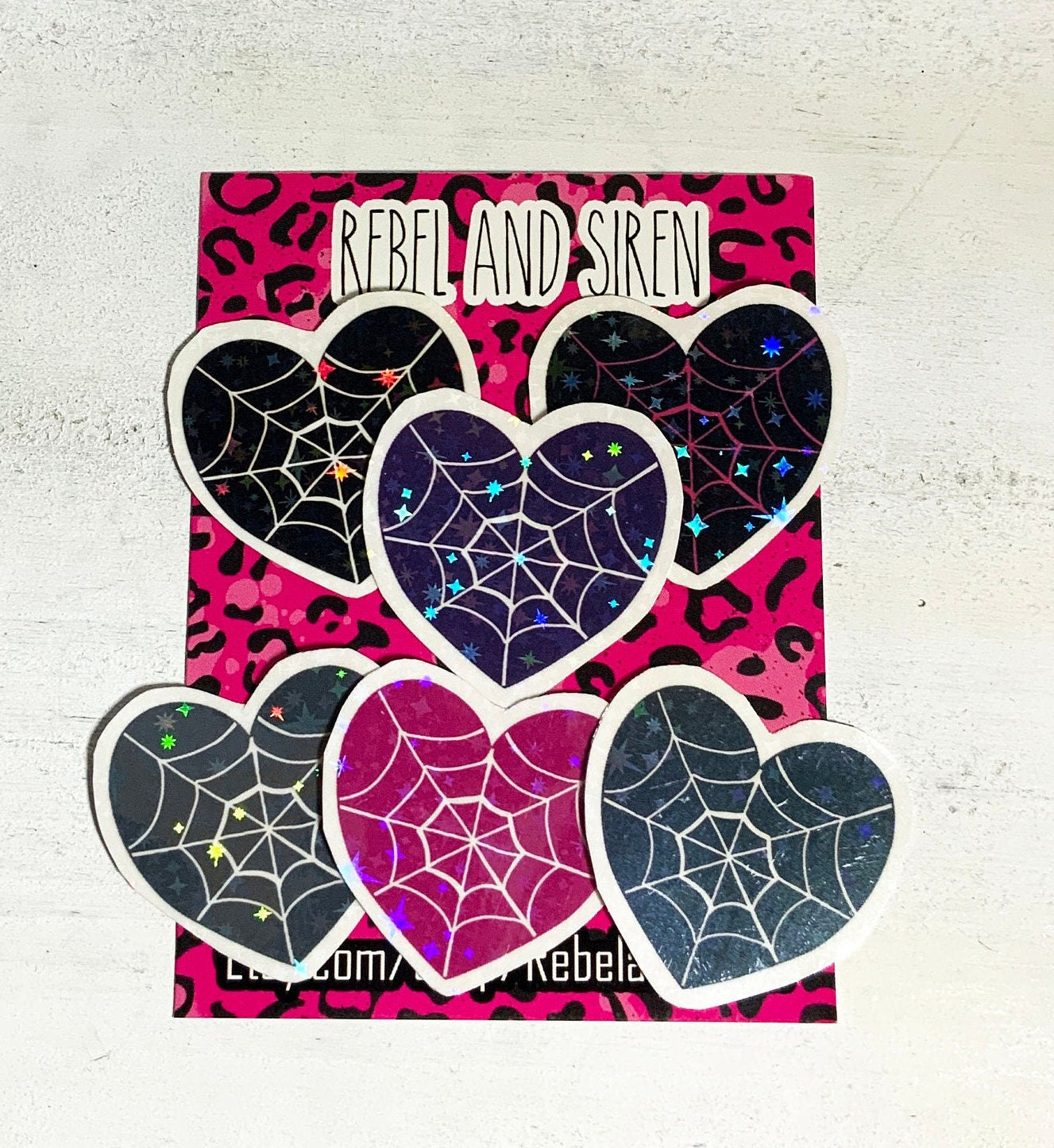 A pack of six spider web heart stickers in various designs, printed on high-quality matte vinyl with a laminated finish for durability.