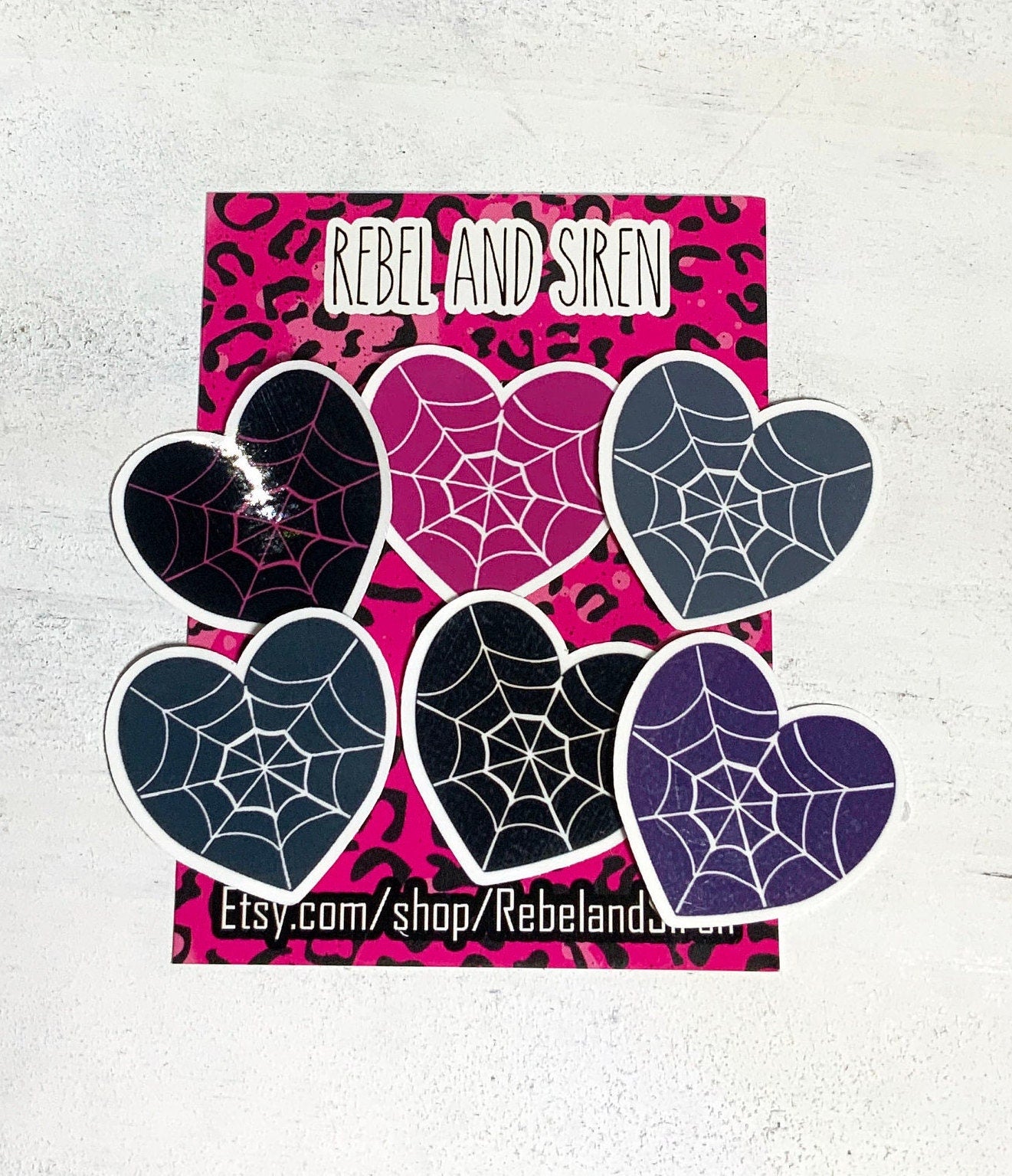 A pack of six spider web heart stickers in various designs, printed on high-quality matte vinyl with a laminated finish for durability.