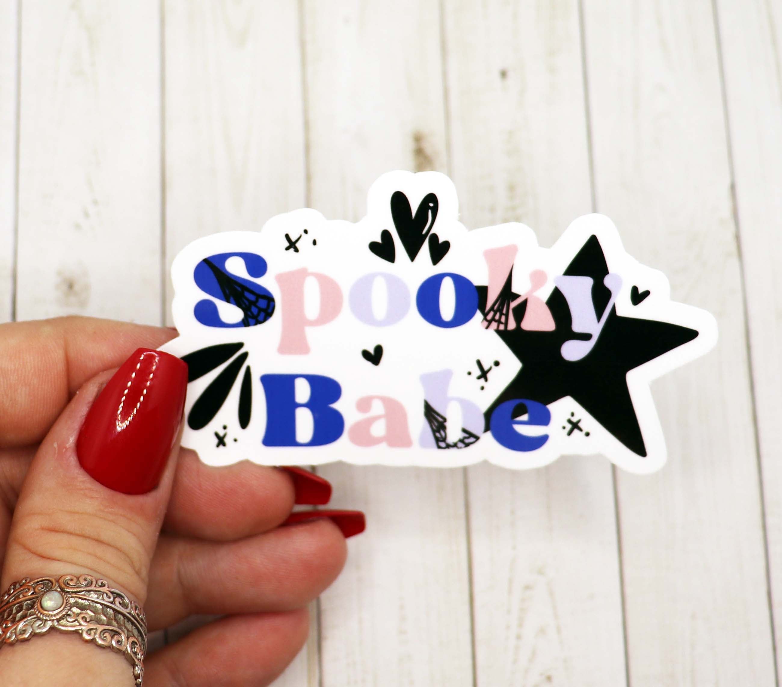 A vibrant Spooky Babe Vinyl Sticker featuring a fun and spooky design, perfect for personalizing various items.