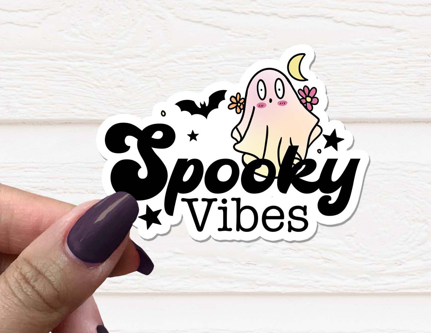 A vibrant Spooky Vibes Vinyl Sticker featuring Halloween-themed designs, perfect for personalizing various items.