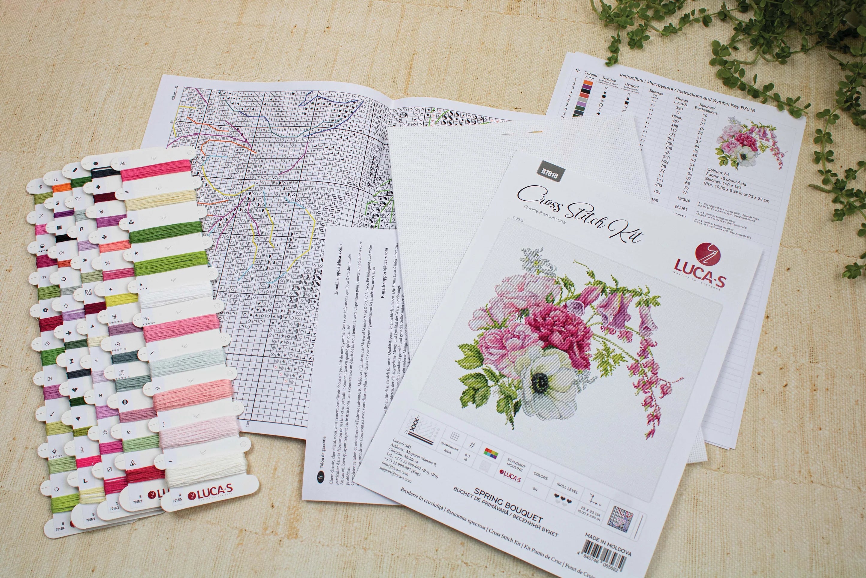 Spring Bouquet B7018L Counted Cross-Stitch Kit featuring colorful threads, canvas, and needle for crafting.