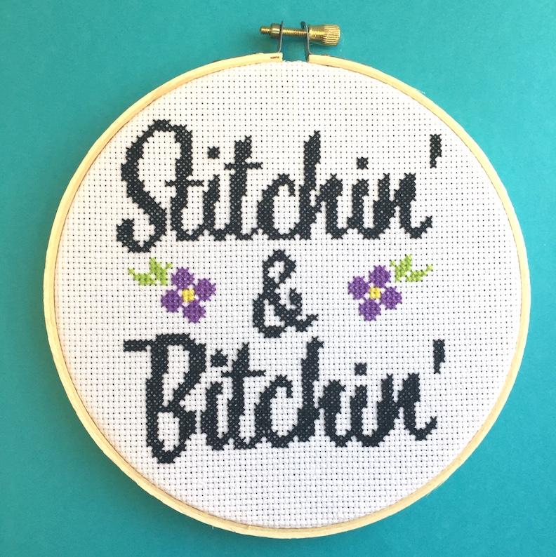 Stitchin' & Bitchin' Counted Cross Stitch DIY Kit featuring floral design elements and a 6-inch wood hoop.