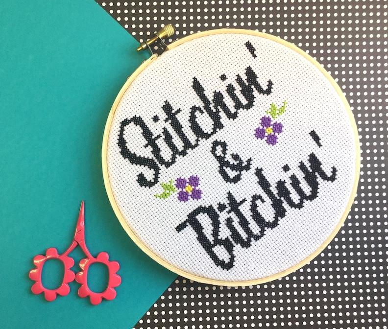 Stitchin' & Bitchin' Counted Cross Stitch DIY Kit featuring floral design elements and a 6-inch wood hoop.