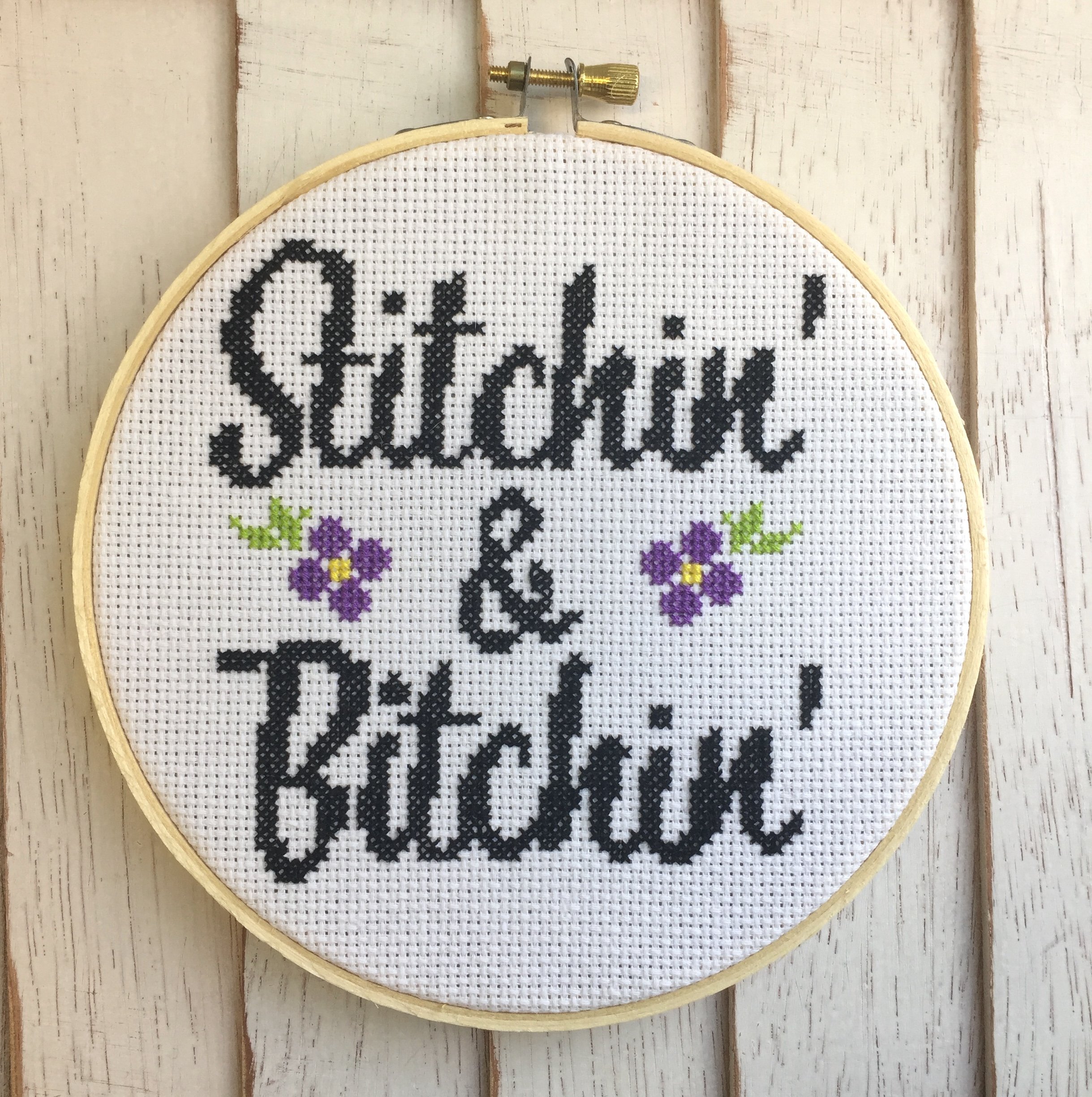 Stitchin' & Bitchin' Counted Cross Stitch DIY Kit featuring floral design elements and a 6-inch wood hoop.