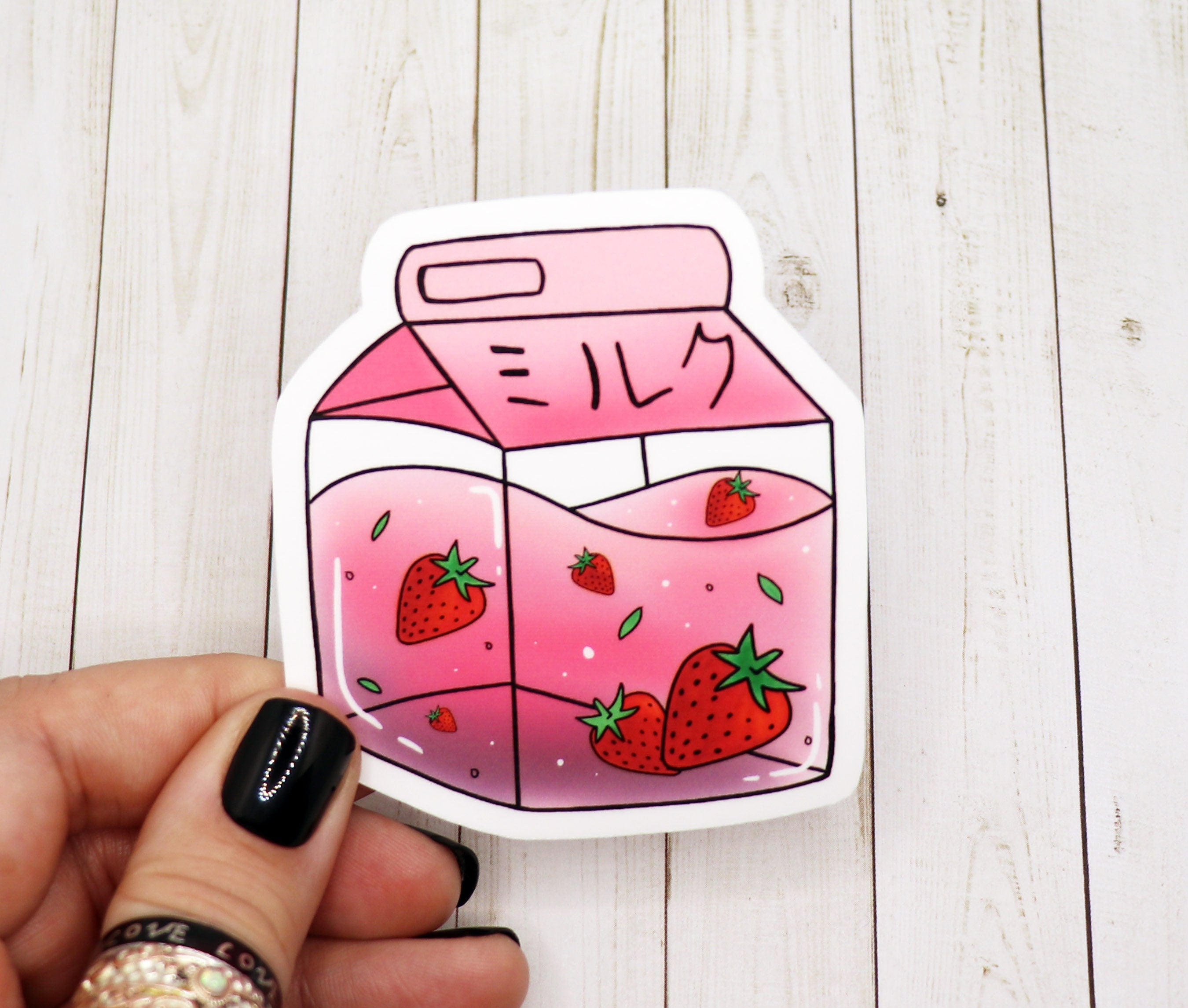 A vibrant Strawberry Milk Die Cut Sticker featuring a cute design, perfect for personalizing various items.