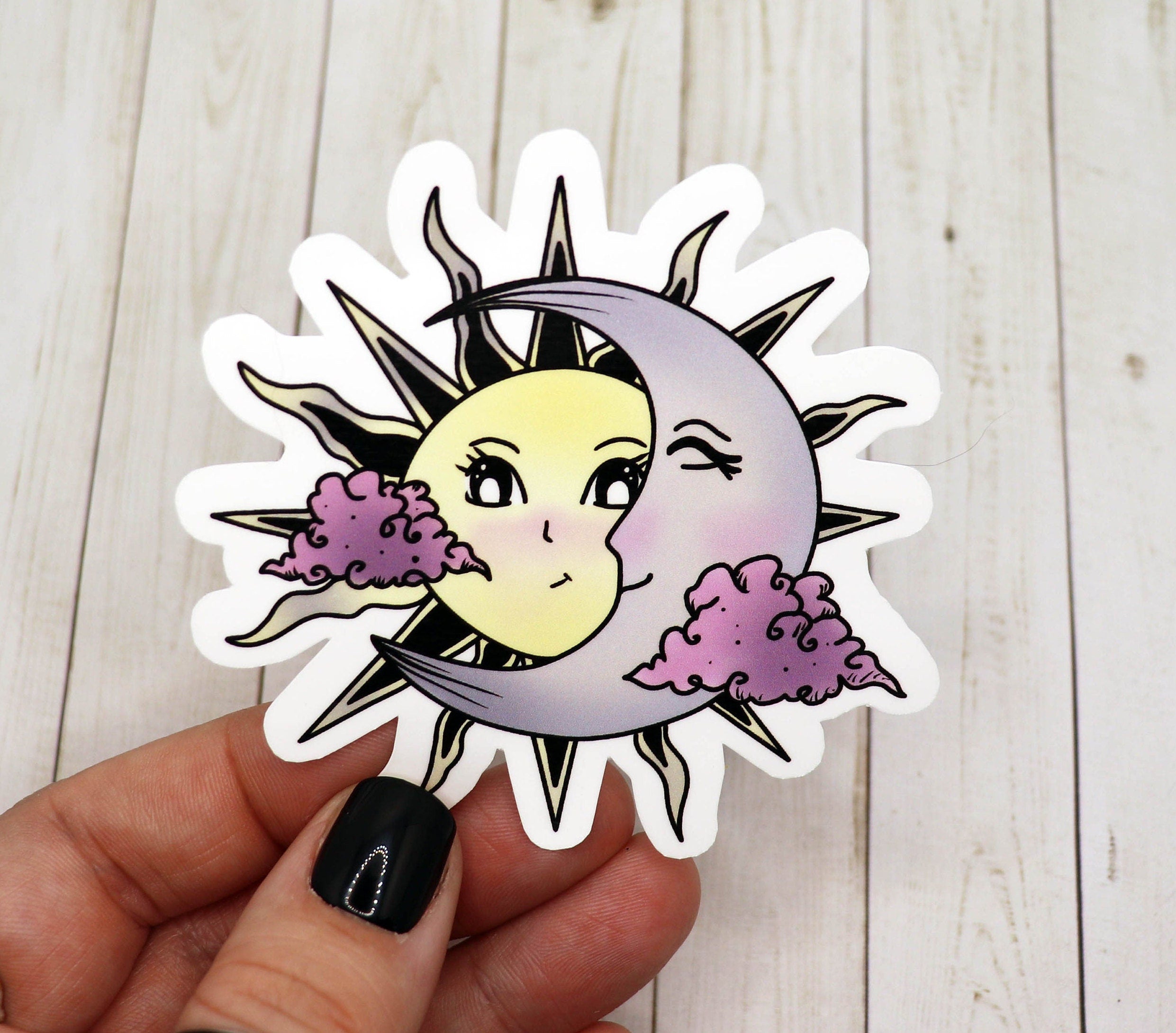 A vibrant sun and moon sticker on a matte vinyl surface, showcasing intricate details and colors.