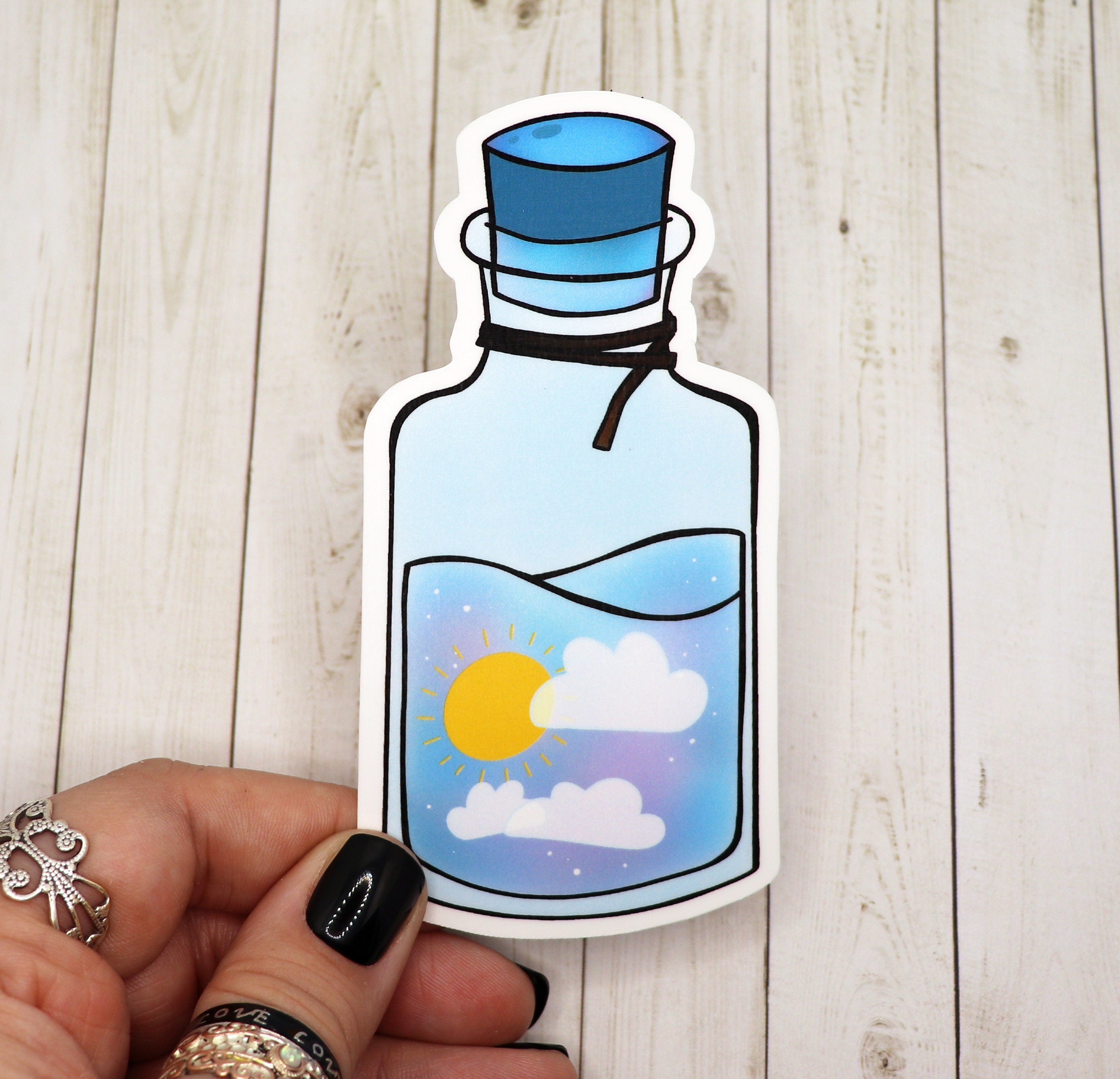 A colorful Sun Potion Bottle Sticker on a white background, showcasing its vibrant design and matte finish.