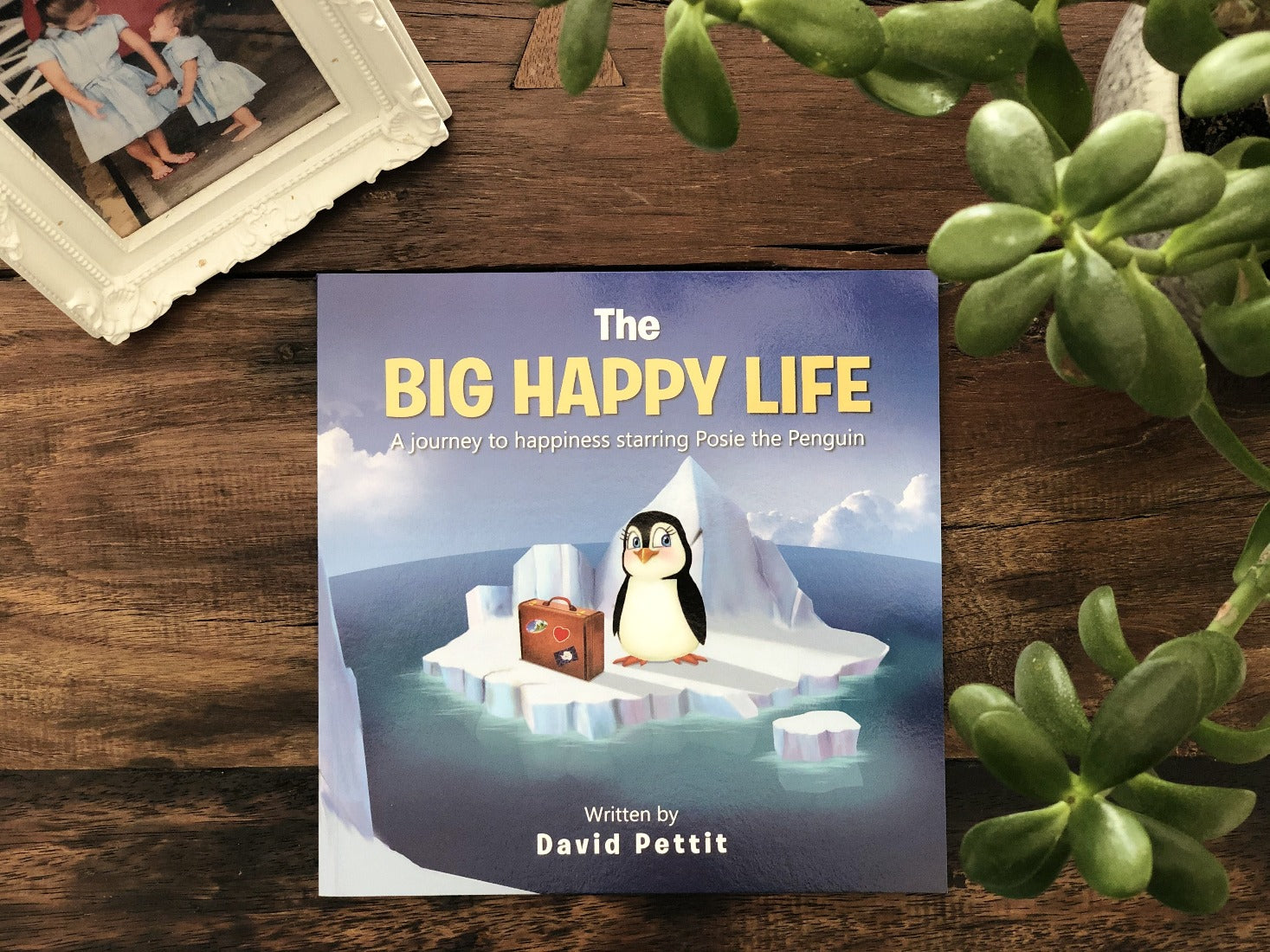 Cover of 'The BIG Happy Life' featuring Posie the Penguin on a colorful adventure, symbolizing self-discovery and happiness.