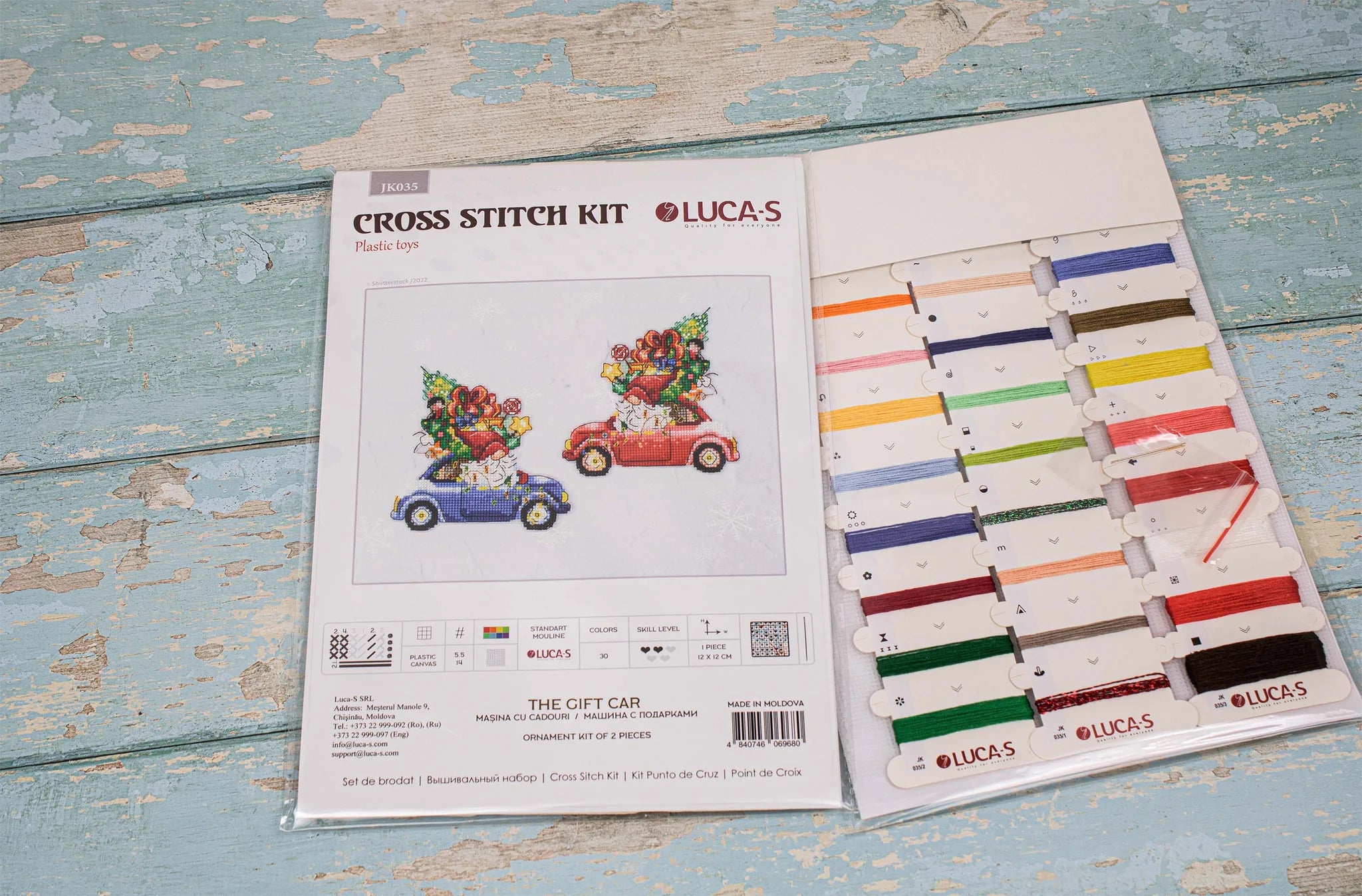 The Gift Car JK035L Counted Cross-Stitch Kit featuring colorful threads, Aida Plastic canvas, and a needle, perfect for crafting.