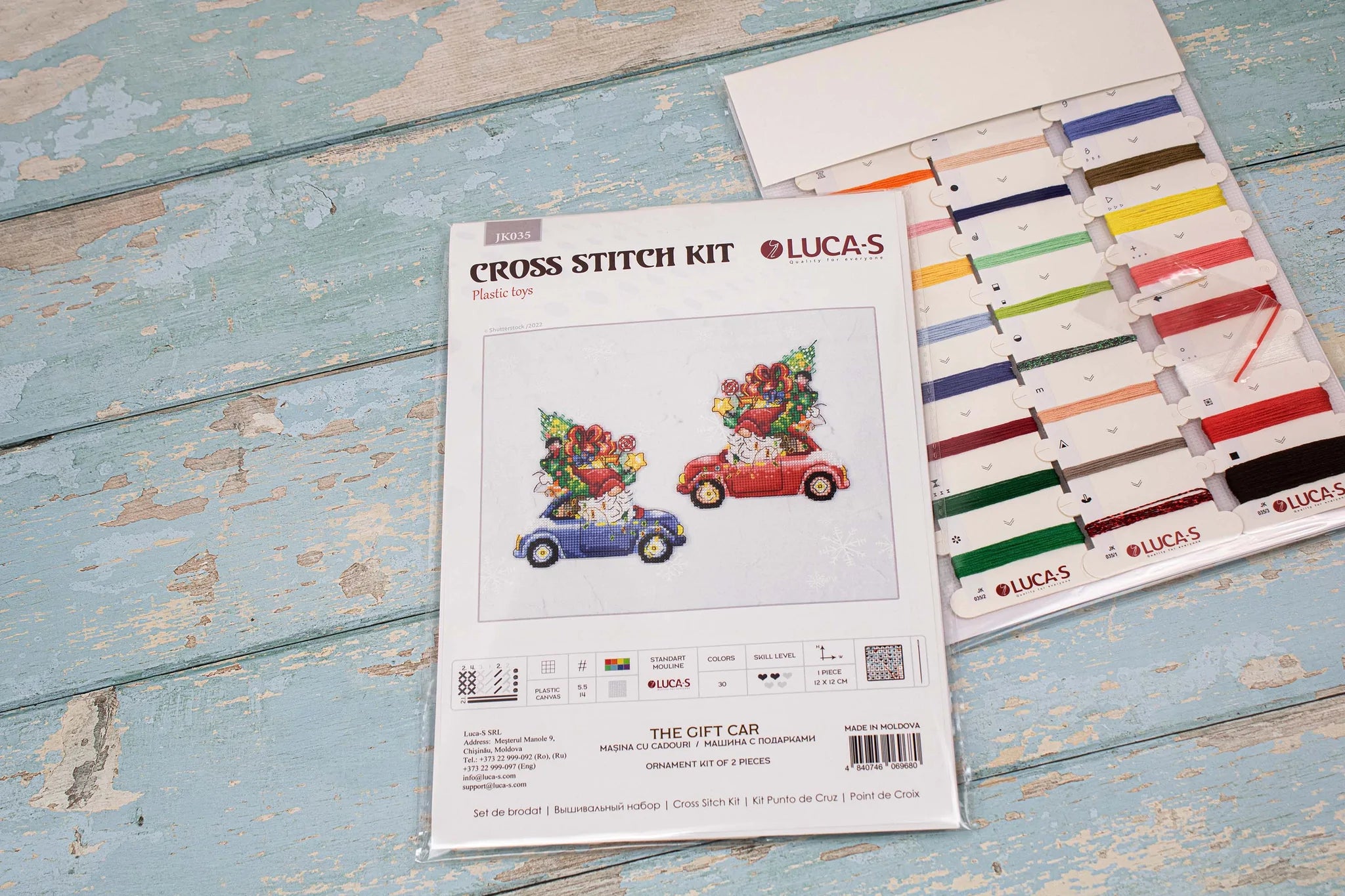 The Gift Car JK035L Counted Cross-Stitch Kit featuring colorful threads, Aida Plastic canvas, and a needle, perfect for crafting.