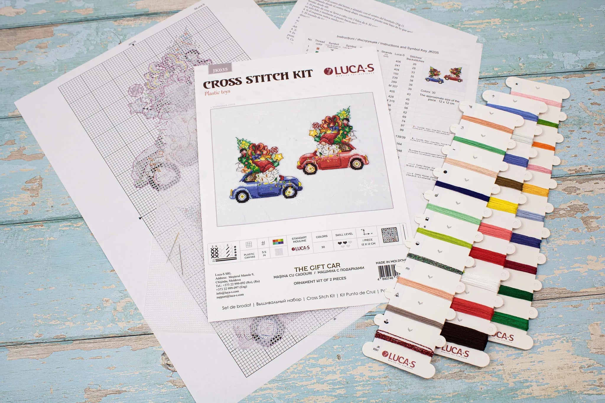 The Gift Car JK035L Counted Cross-Stitch Kit featuring colorful threads, Aida Plastic canvas, and a needle, perfect for crafting.