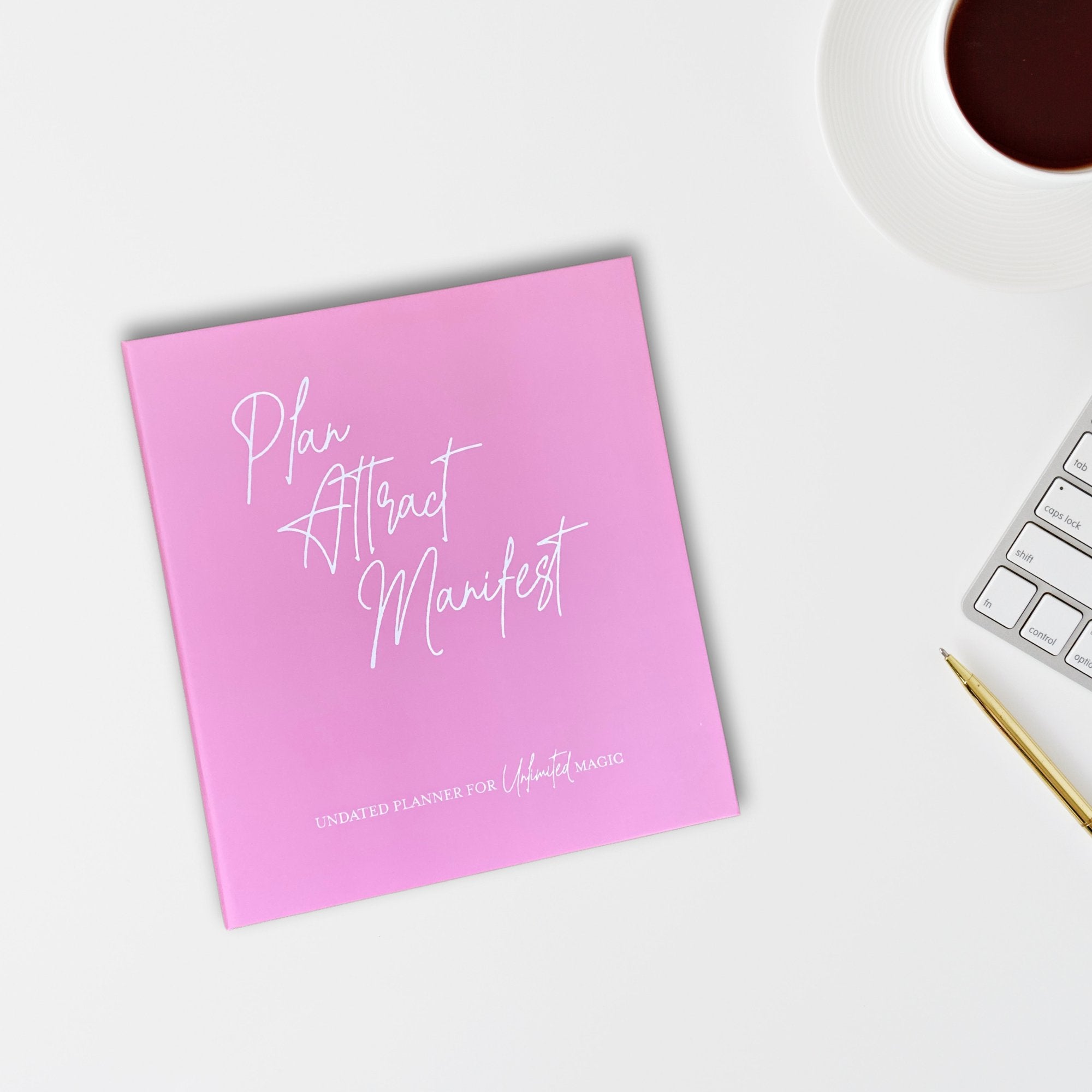 The Manifestation Planner featuring a foil embossed cover with the phrase 'Plan Attract Manifest' on the front.