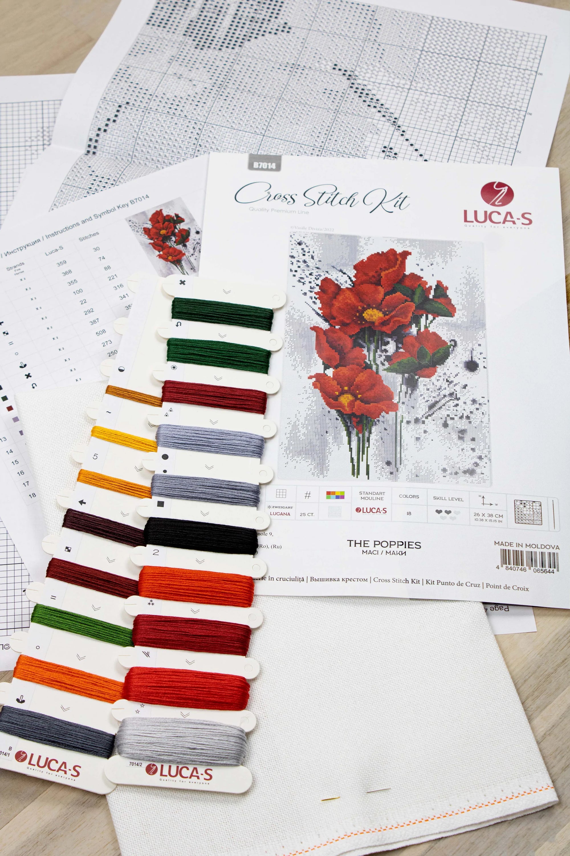 The Poppies B7014L Counted Cross-Stitch Kit featuring vibrant threads and canvas for crafting.