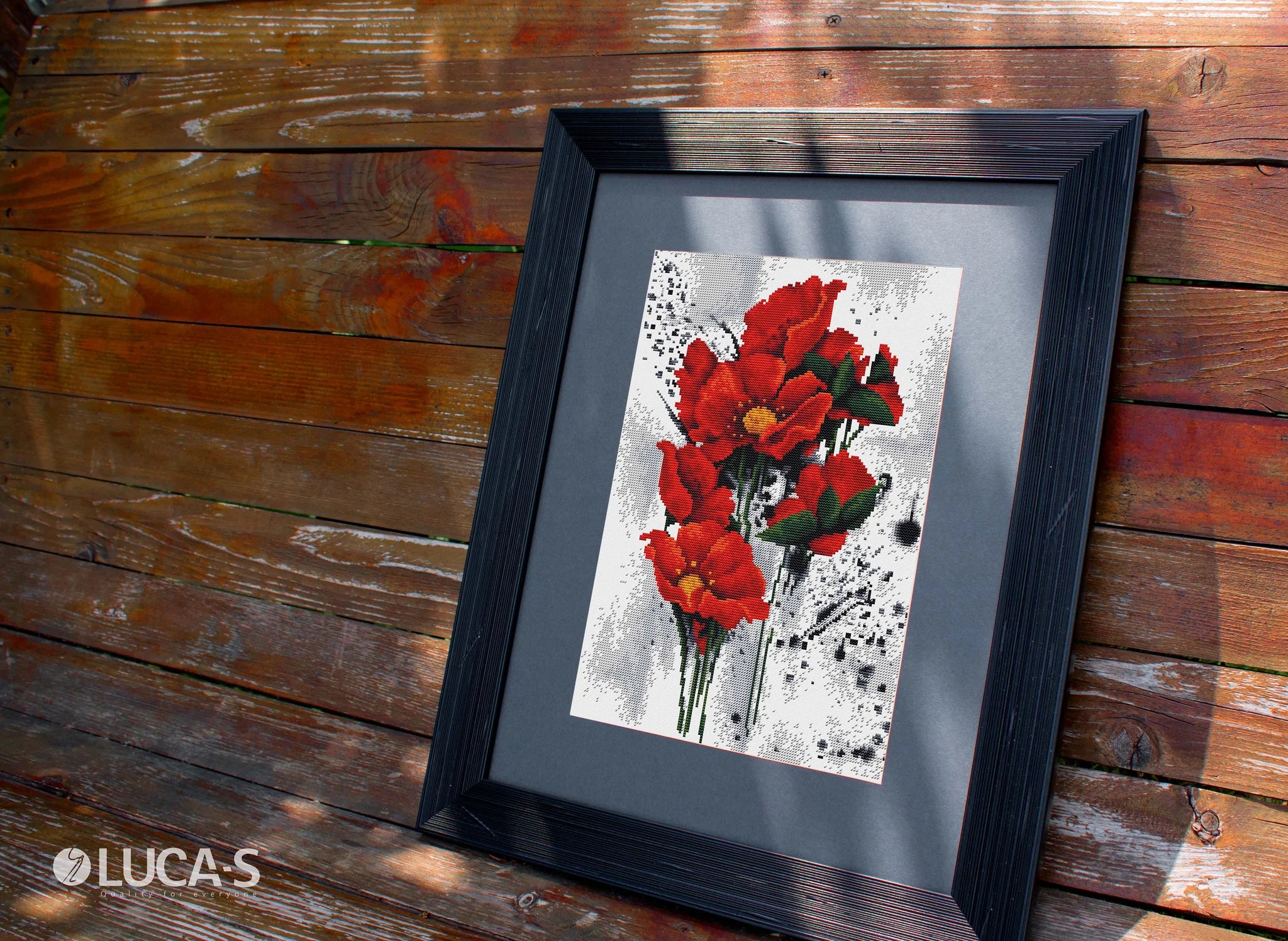 The Poppies B7014L Counted Cross-Stitch Kit featuring vibrant threads and canvas for crafting.