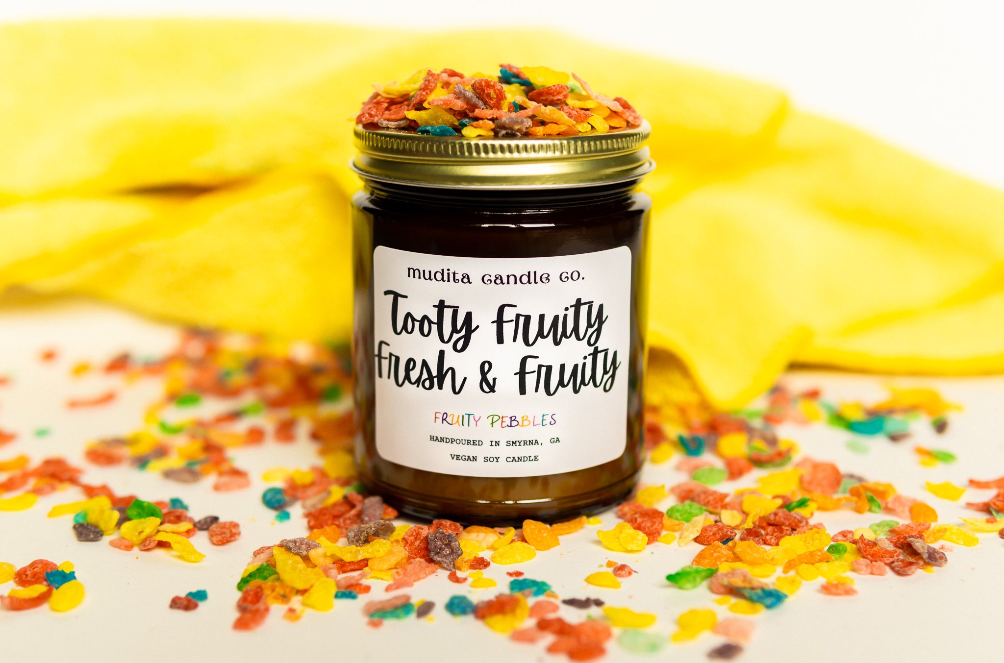 Totty Fruity Fresh & Fruity candle in amber glass jar with gold lid, showcasing vibrant fruity design.