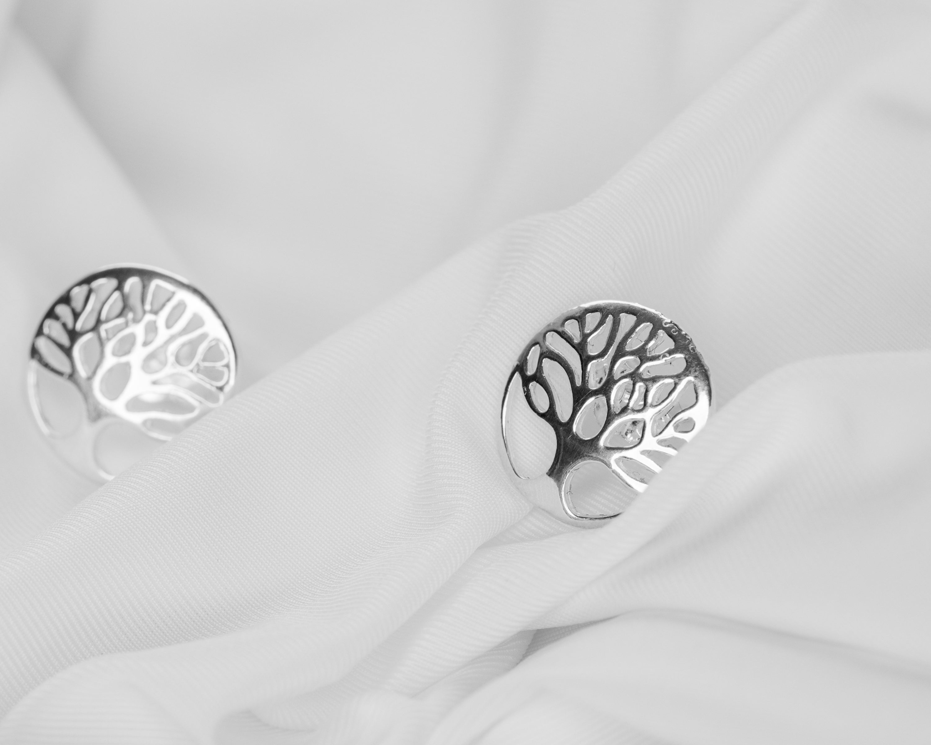 Sterling silver Tree of Life earrings featuring intricate design symbolizing strength and togetherness.