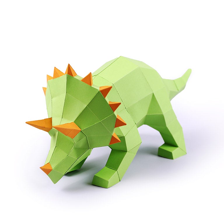 A vibrant green Triceratops 3D paper model lamp with orange horn spikes, showcasing intricate details and a unique design.