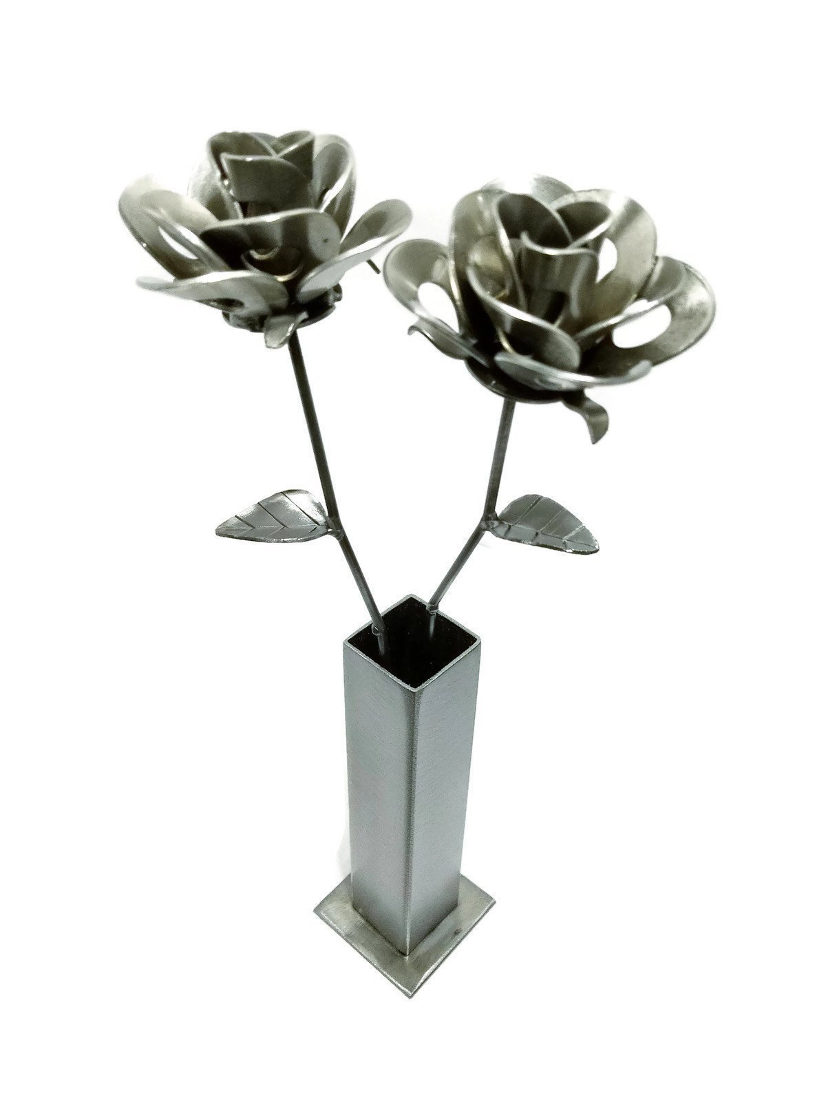 Two handcrafted metal roses in a rustic vase, showcasing a unique steampunk design made from recycled materials.