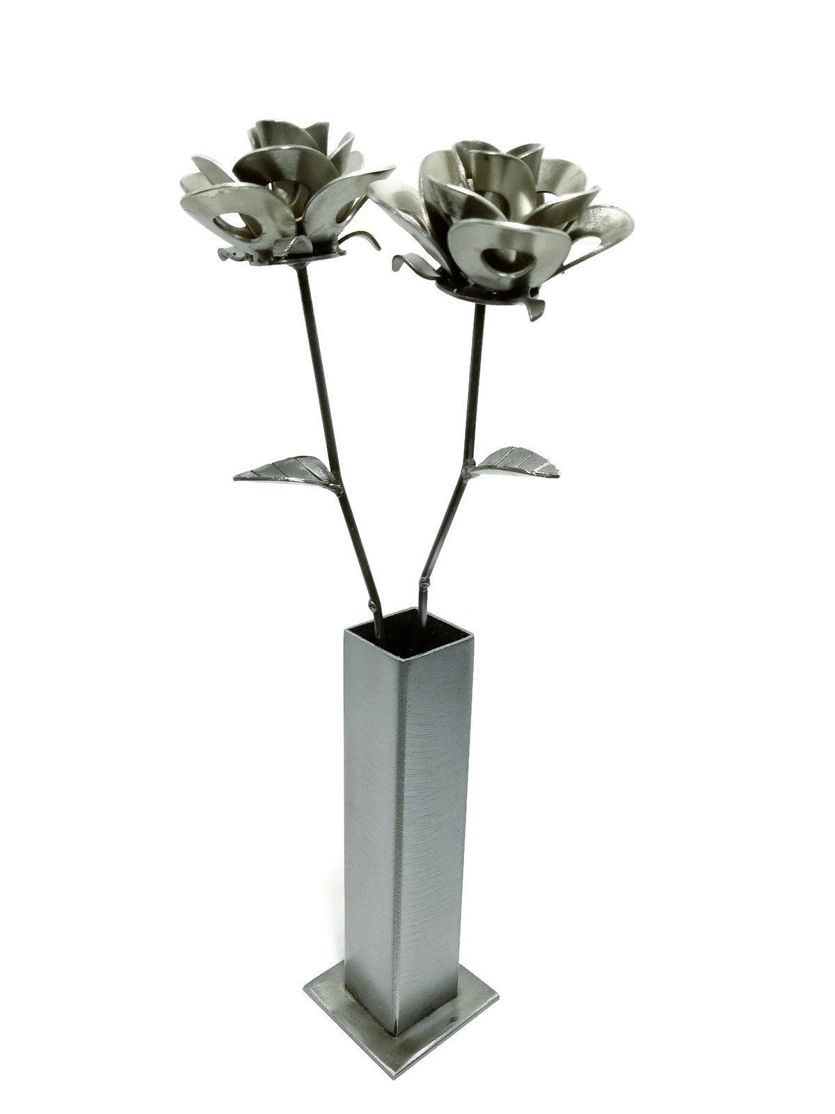 Two handcrafted metal roses in a rustic vase, showcasing a unique steampunk design made from recycled materials.