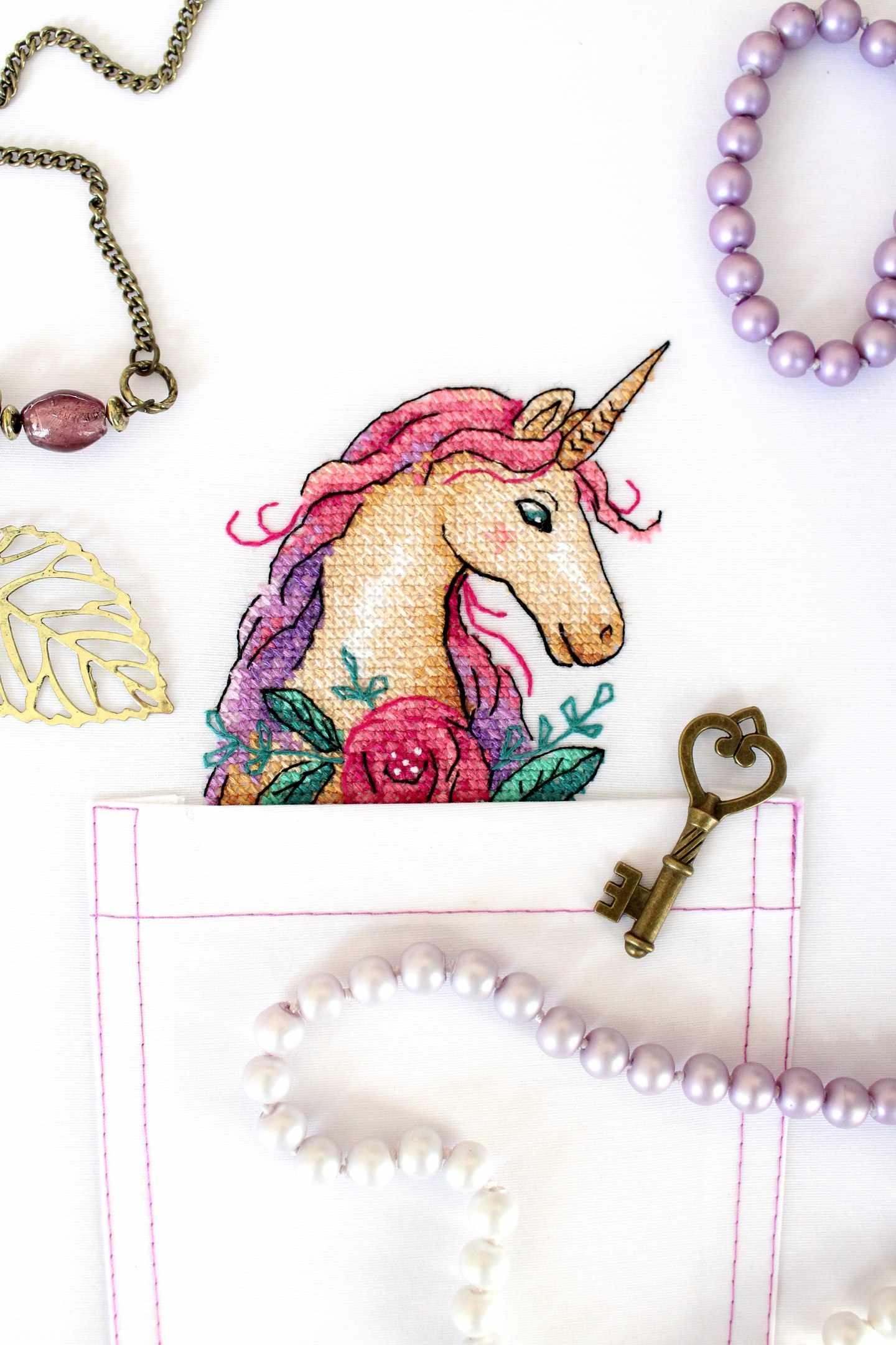 Unicorn cross stitch kit featuring colorful threads and water soluble canvas, perfect for crafting enthusiasts.