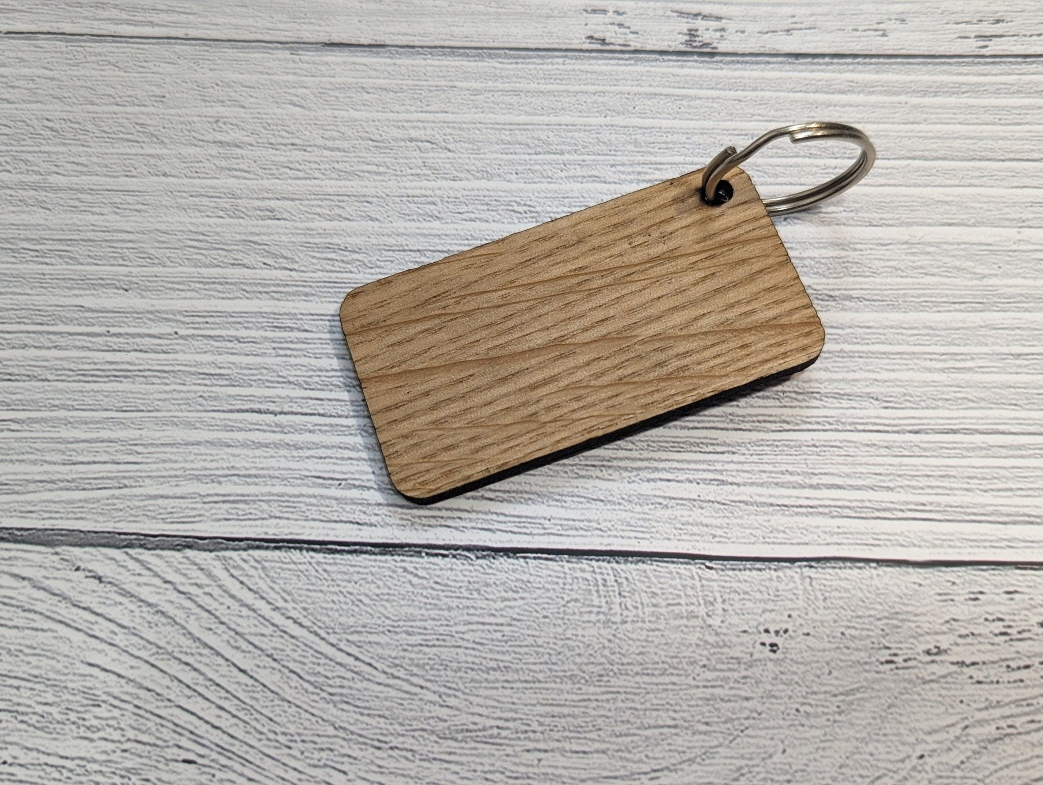 Handmade Union Jack Keyring made from oak MDF, featuring laser engraved design, measuring 65mm x 35mm.