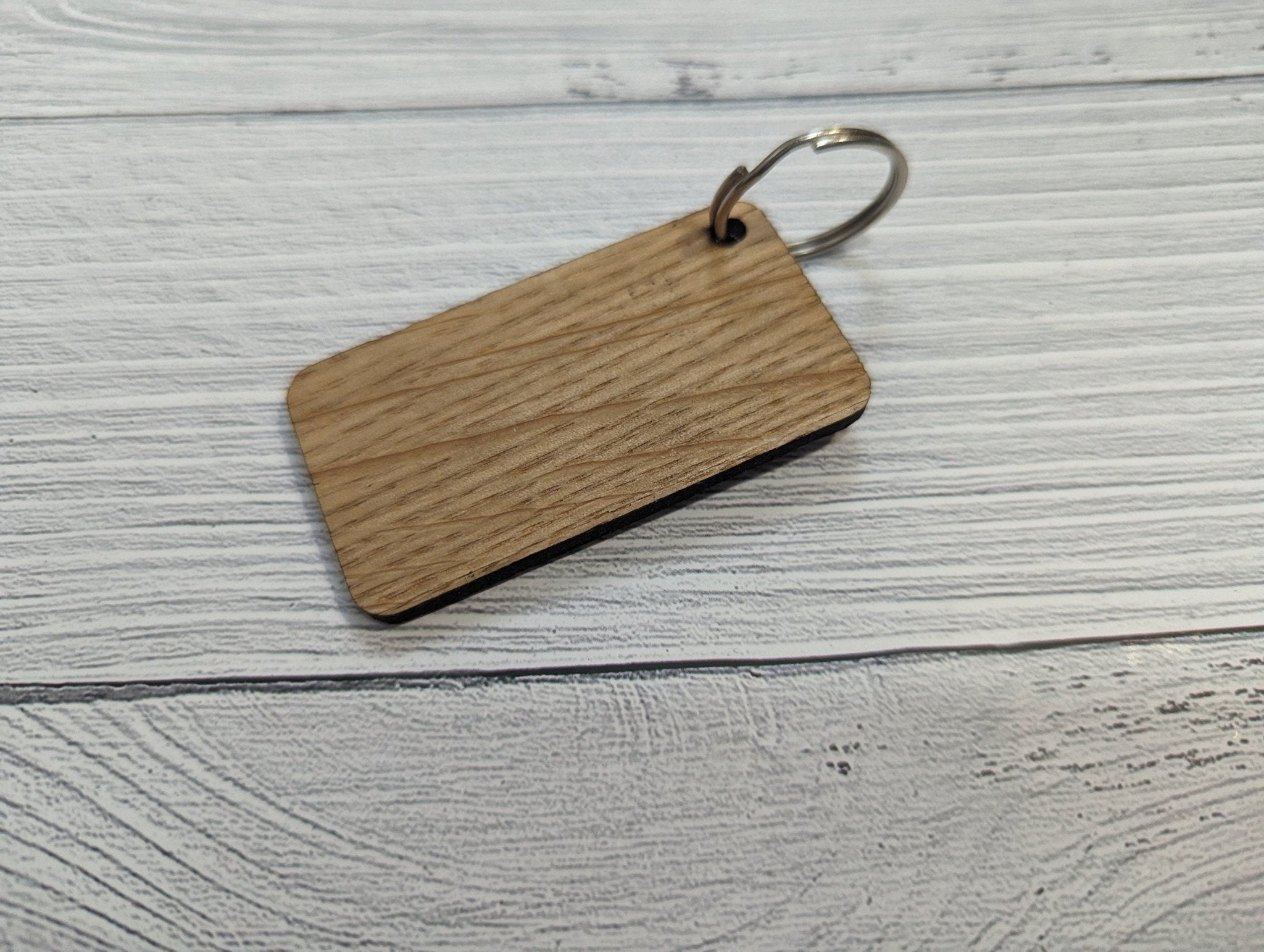 Handmade Union Jack Keyring made from oak MDF, featuring laser engraved design, measuring 65mm x 35mm.