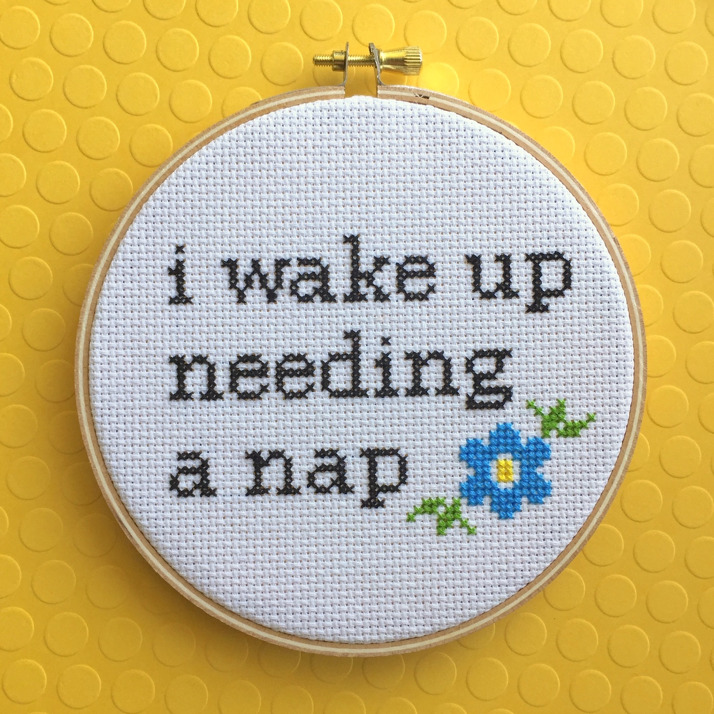 Wake Up Needing a Nap Counted Cross Stitch DIY Kit featuring floral elements and text, perfect for intermediate crafters.