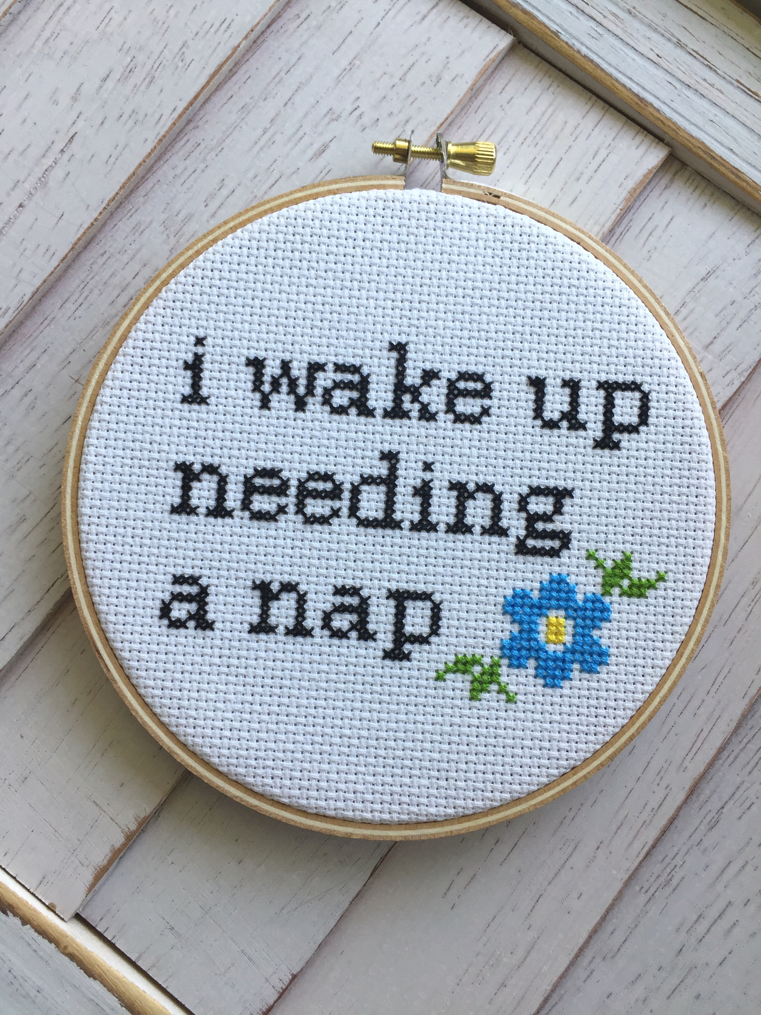 Wake Up Needing a Nap Counted Cross Stitch DIY Kit featuring floral elements and text, perfect for intermediate crafters.