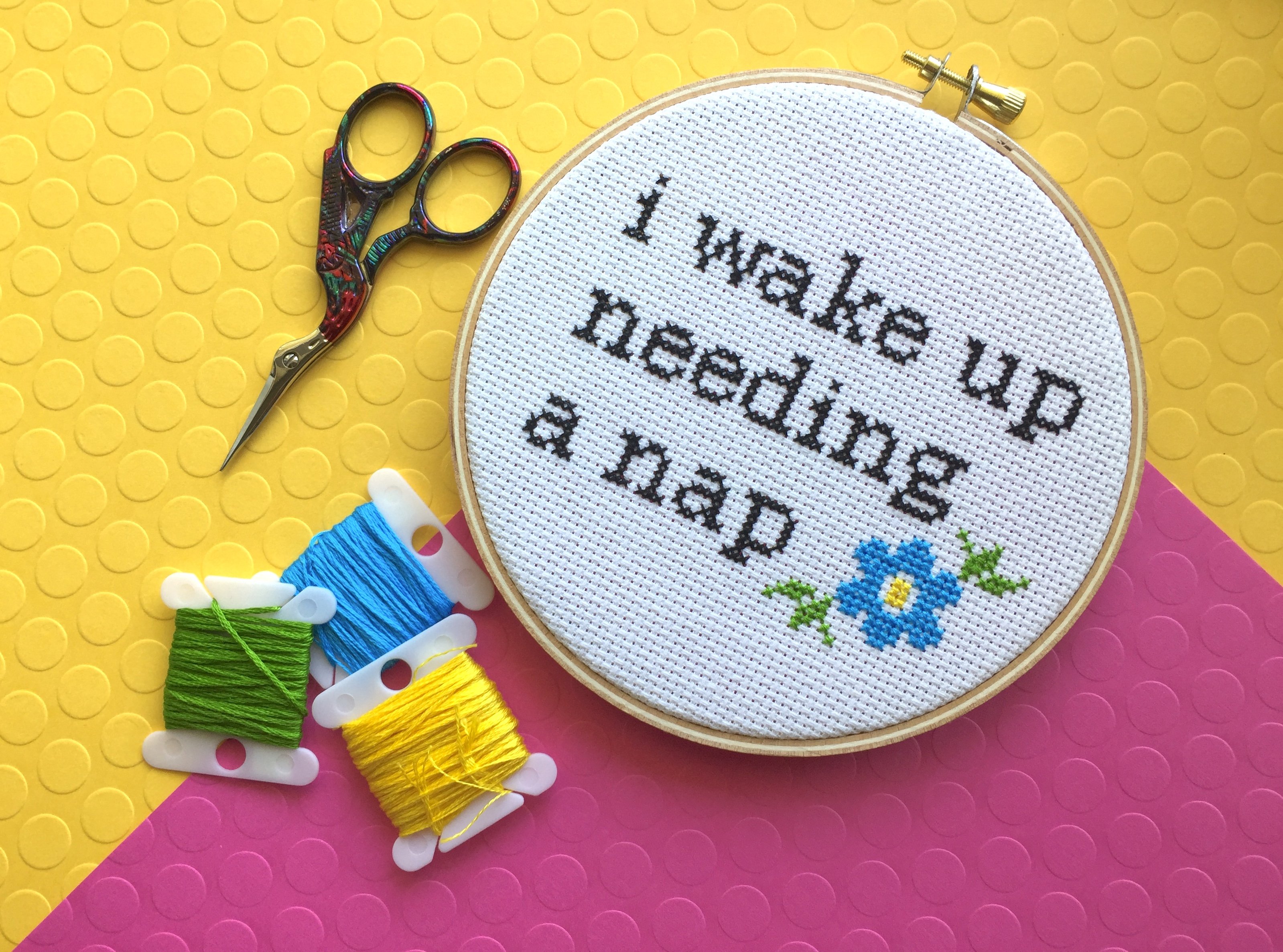 Wake Up Needing a Nap Counted Cross Stitch DIY Kit featuring floral elements and text, perfect for intermediate crafters.