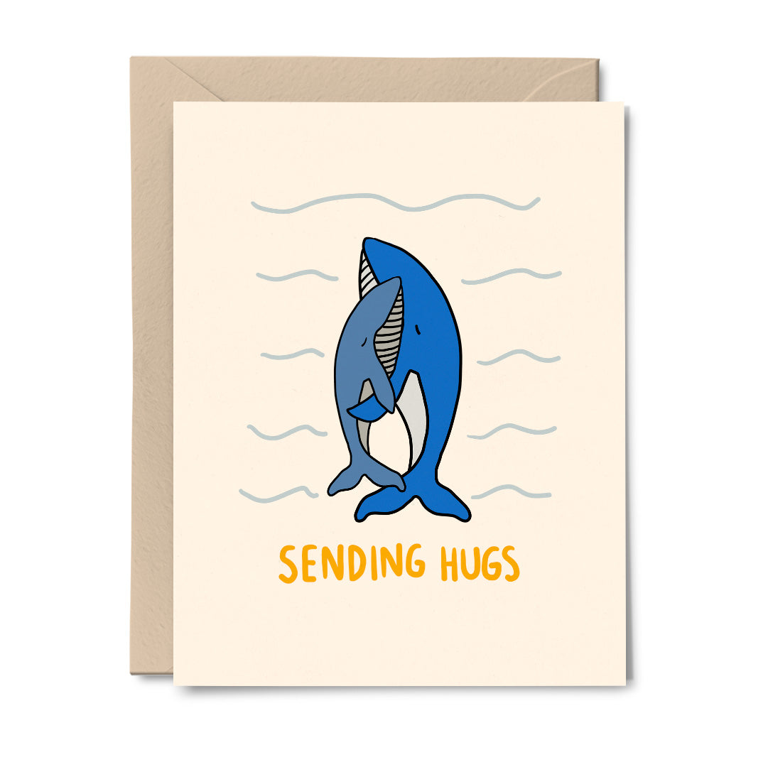 A greeting card featuring two blue whales hugging, with the text 'Sending Hugs' at the bottom.