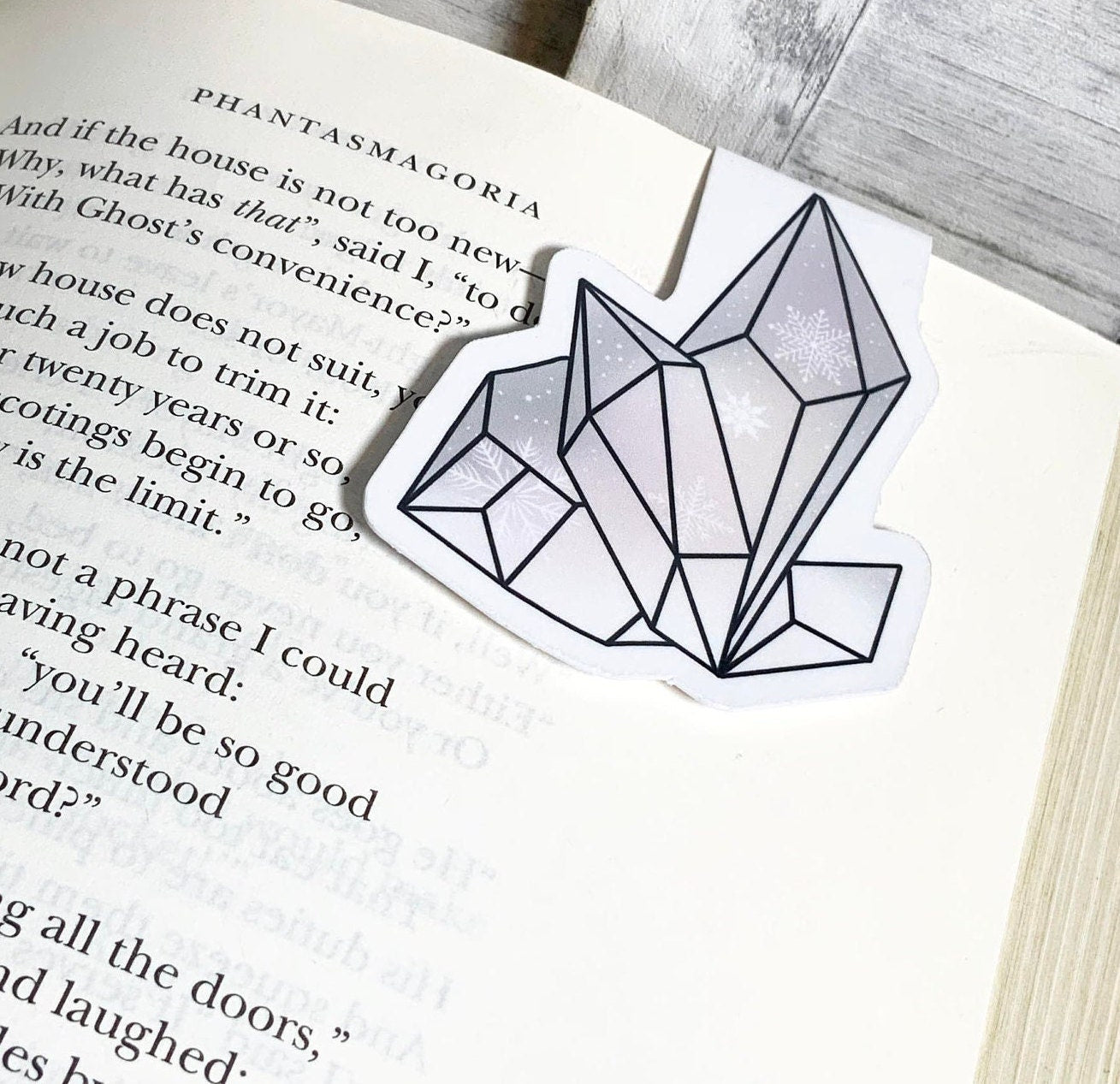 A beautiful white crystal magnetic bookmark, showcasing its elegant design and strong magnets, perfect for avid readers.