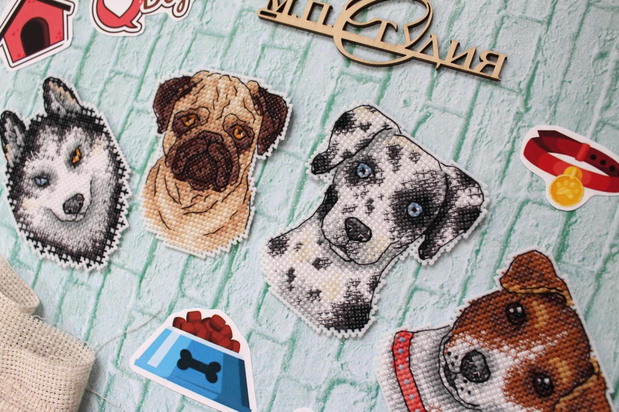 Who Said Woof? Magnets SR-409 Cross Stitch Kit featuring colorful threads, plastic canvas, and finished dog-themed magnets.